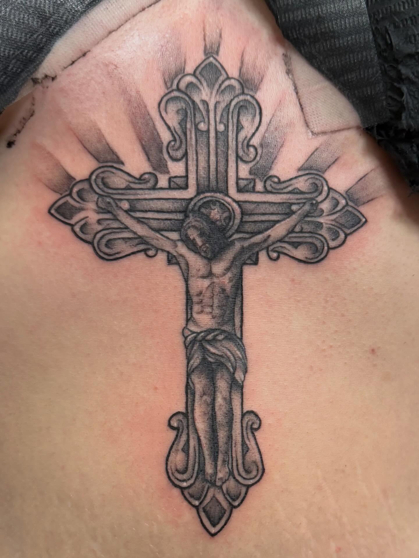 Religious cross realism tattoo on the chest by Madilynn Klassen