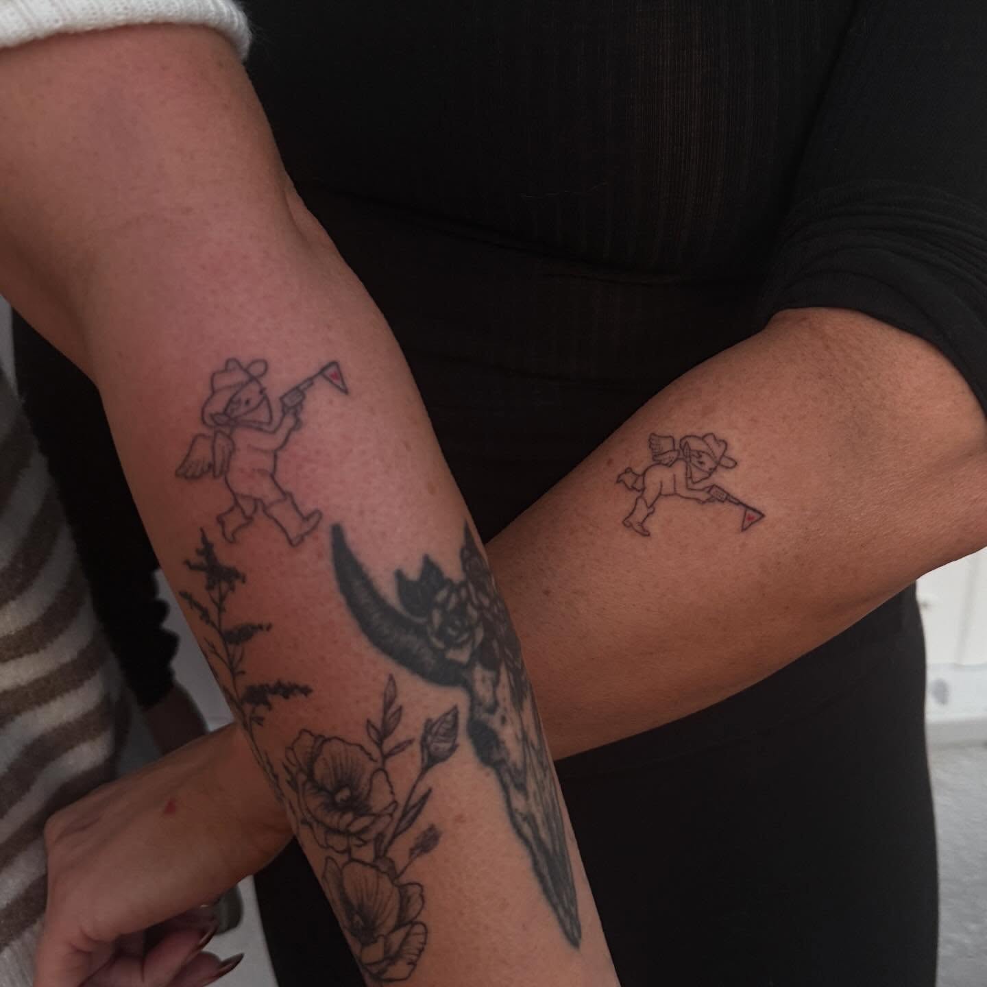 Angels and flowers black and grey tattoo on the forearm by springgreens