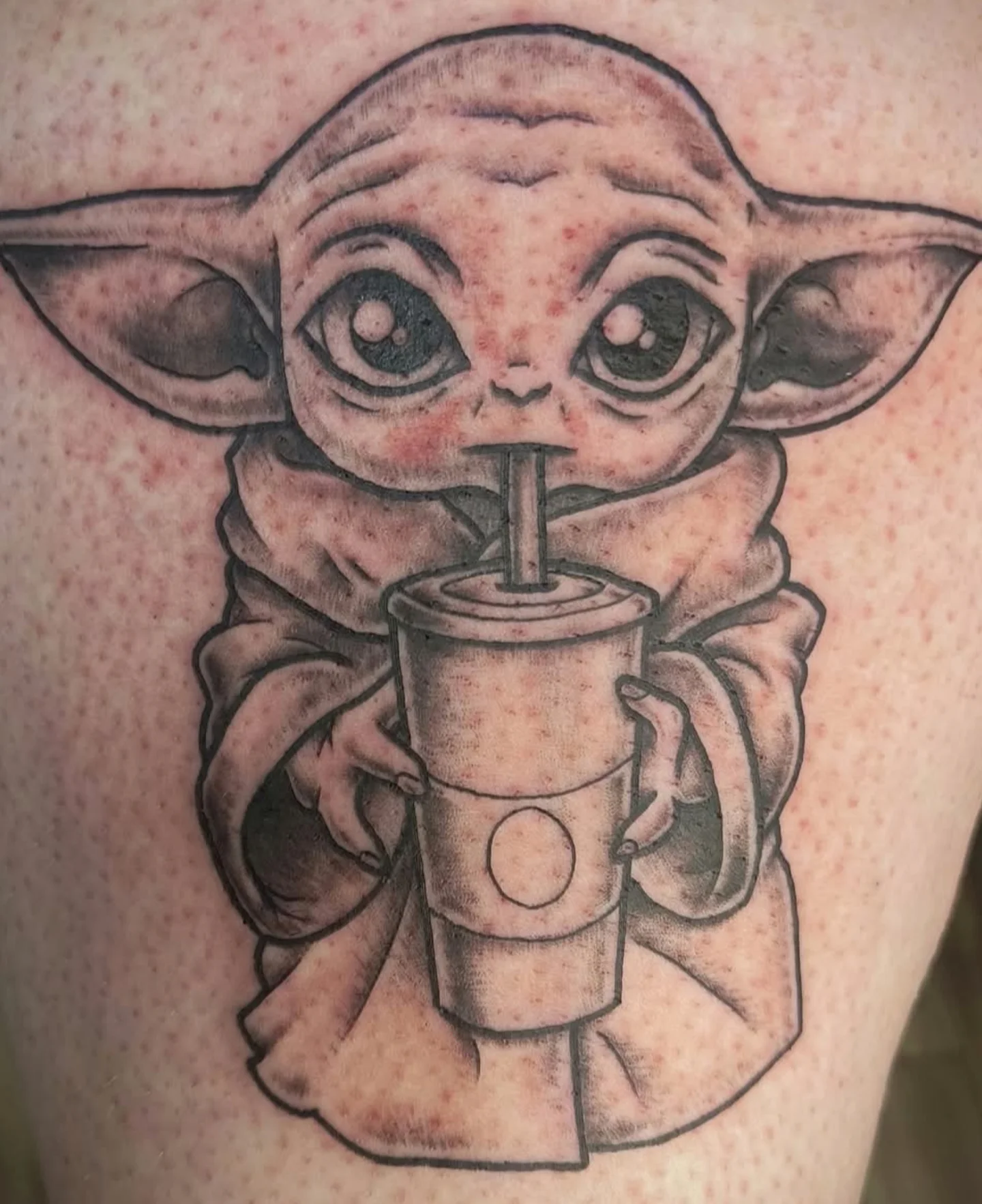 Baby Yoda black and grey tattoo on the thigh by Reid
