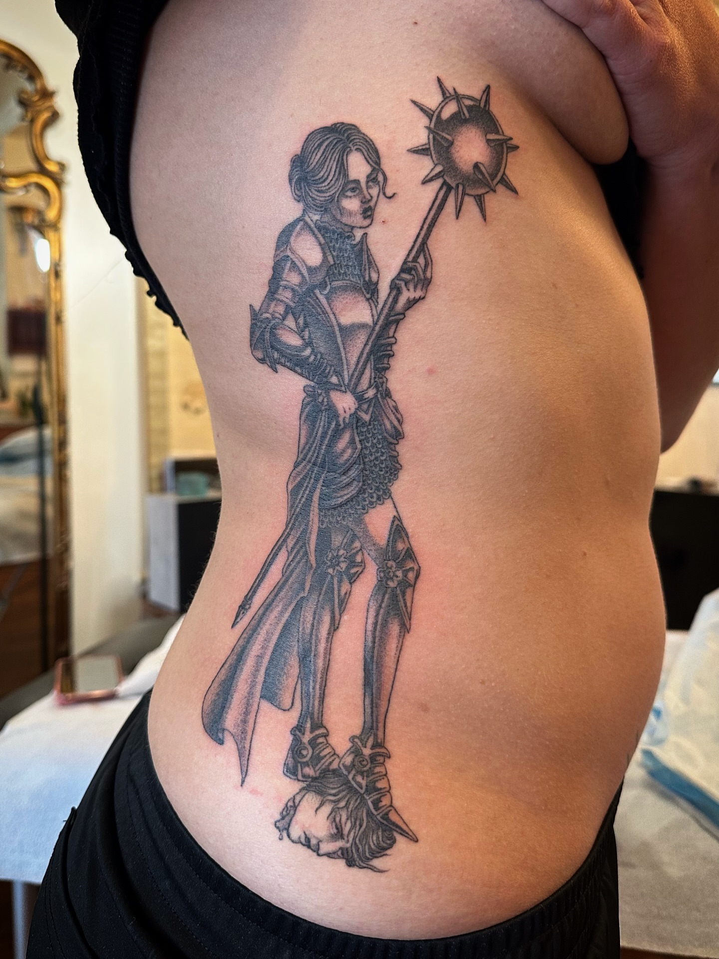 Female warrior black and grey tattoo on the ribs by Bree Lin