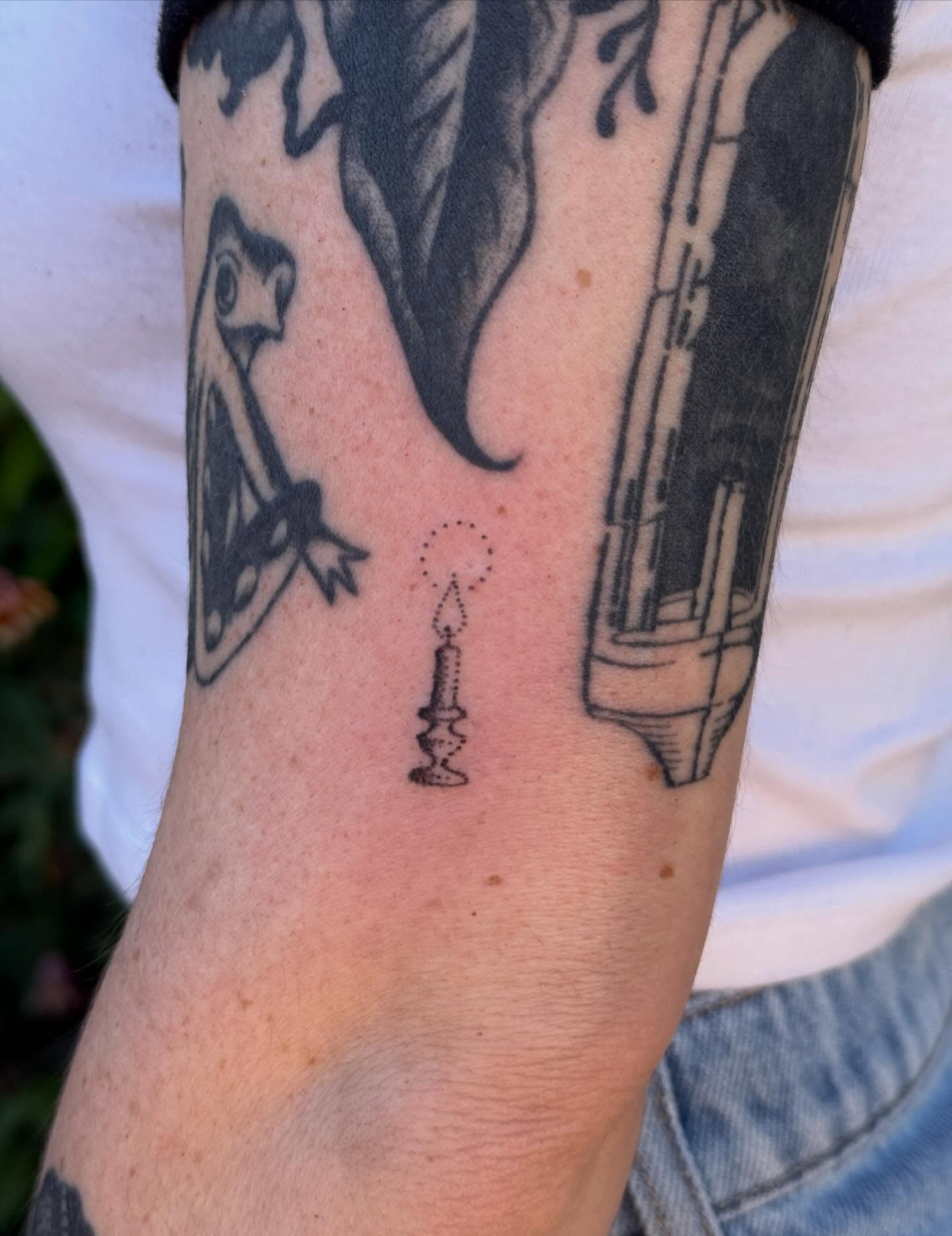Candle dotwork tattoo on the forearm by springgreens
