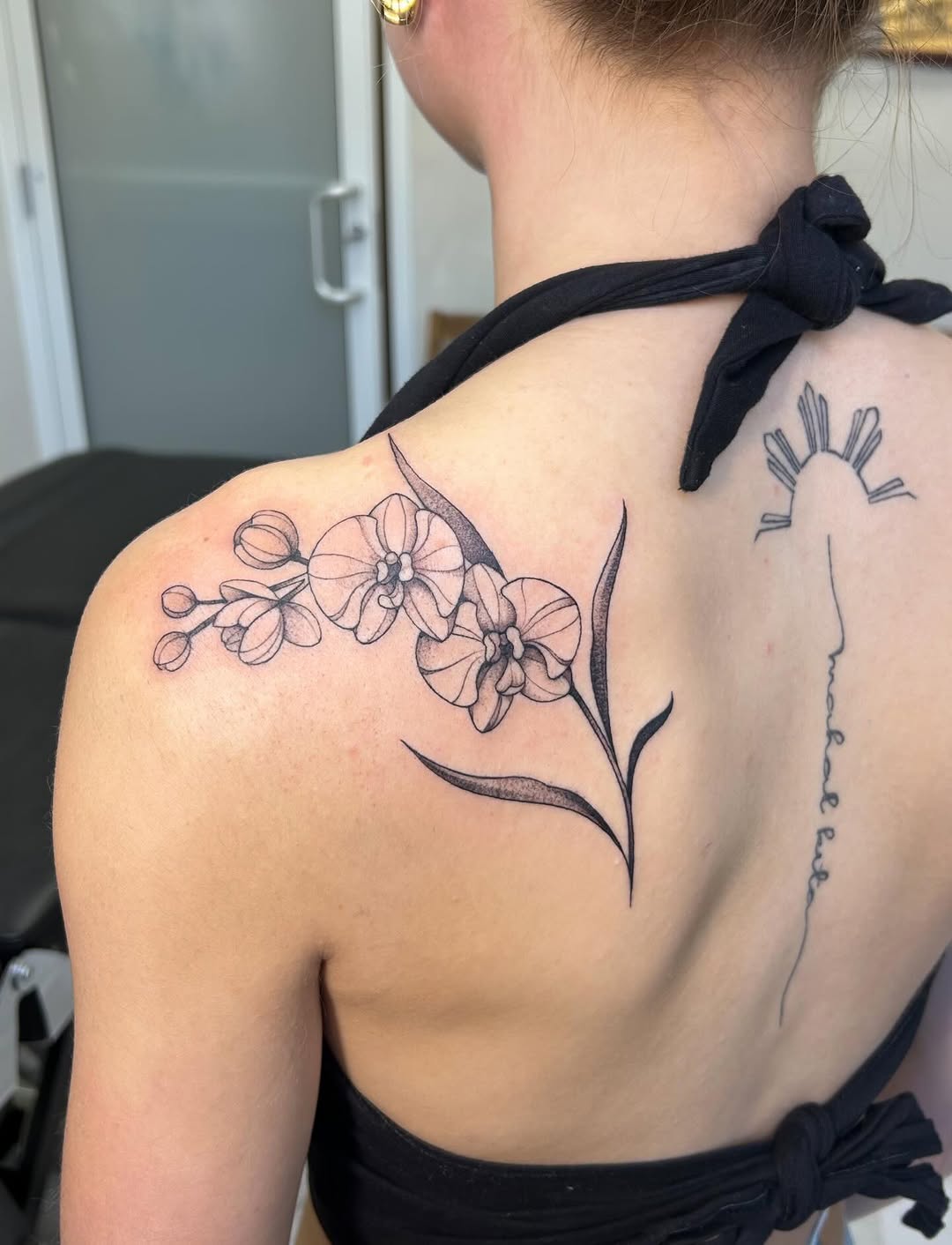 Orchid branch fine line tattoo on the shoulder by kuna ink