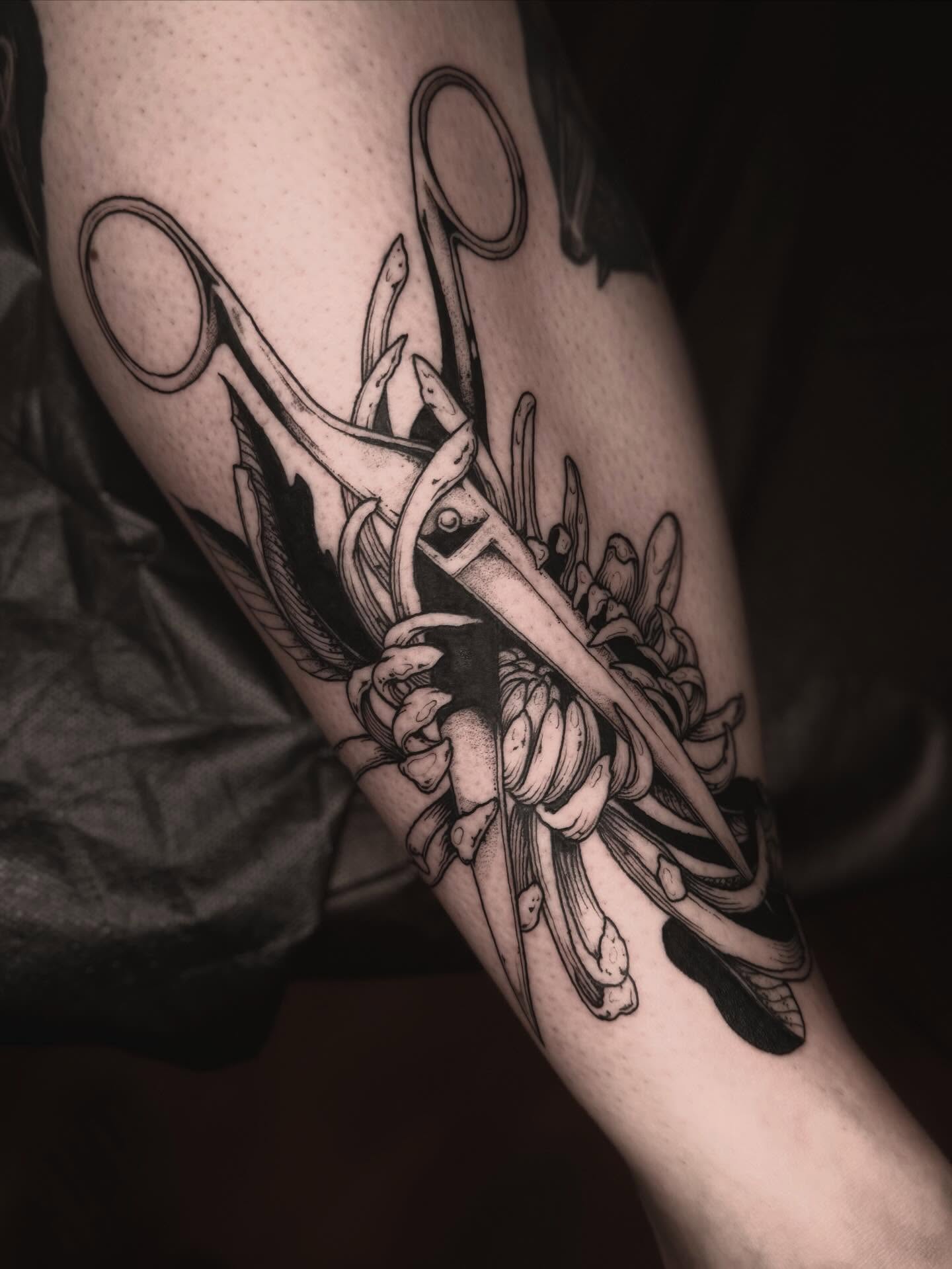 Scissors and flowers black and grey tattoo on the forearm by 𝐋𝐢𝐬𝐚 𝐊𝐨𝐫𝐳𝐞𝐧𝐨𝐰𝐬𝐤𝐢