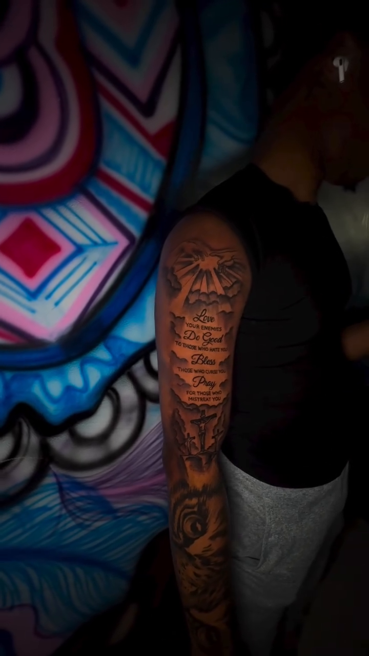 Religious text and imagery lettering script tattoo by Dope