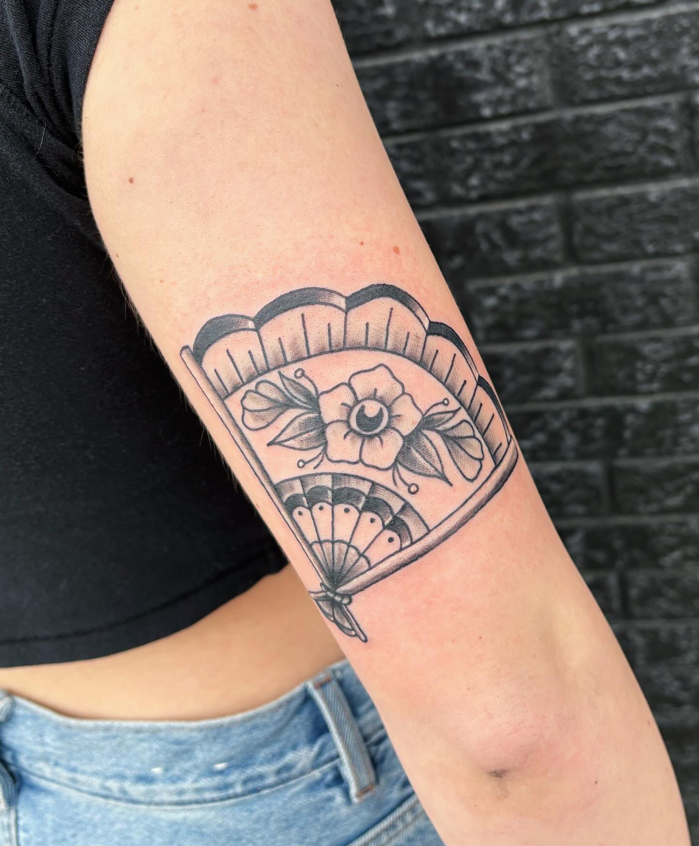 Flower and fan American traditional tattoo on the forearm by Demi Flores 🖤