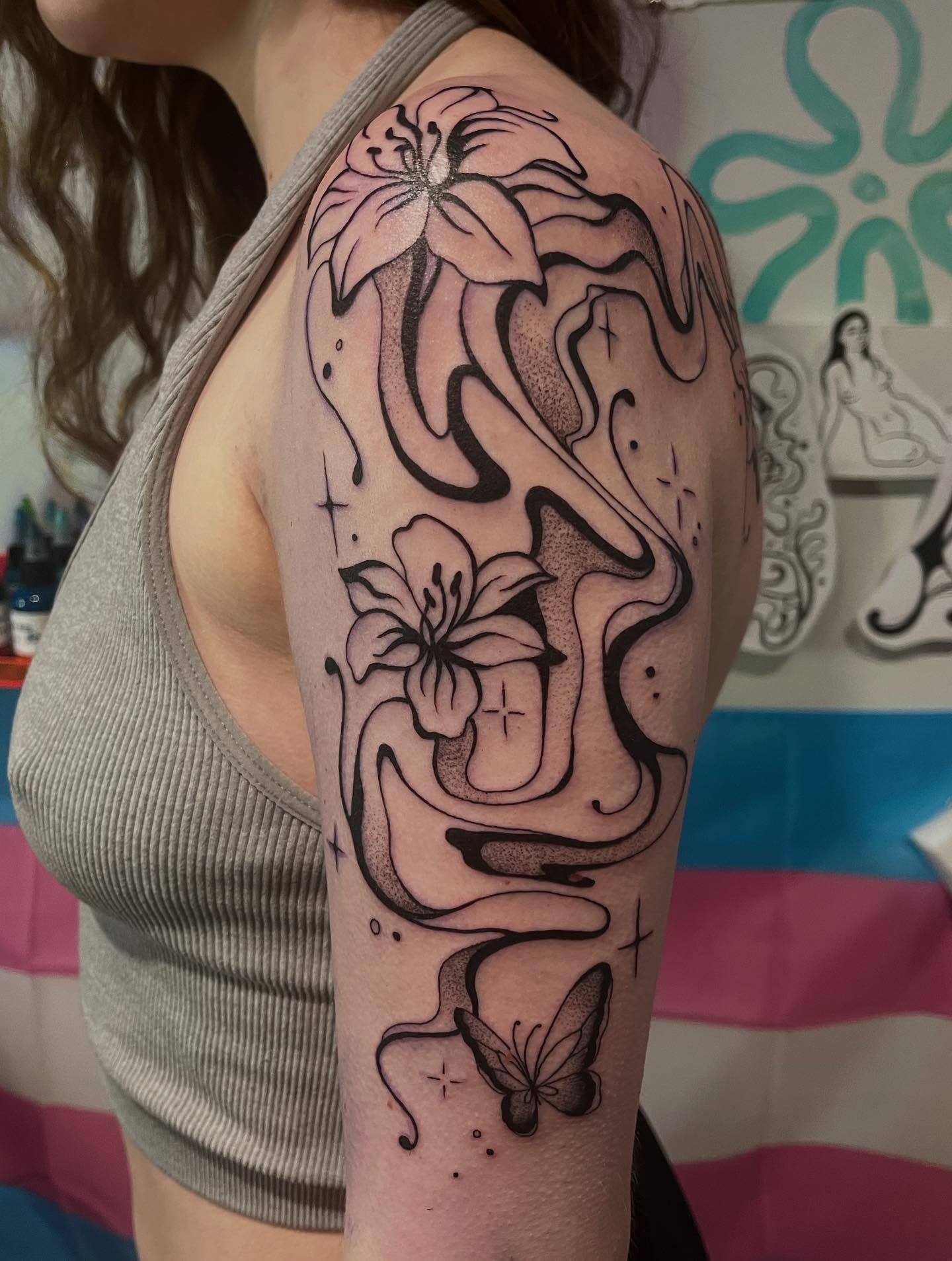 Lilies and butterfly dotwork tattoo on the upper arm by 🖤Jess Pereira🖤, Framingham, Massachusetts