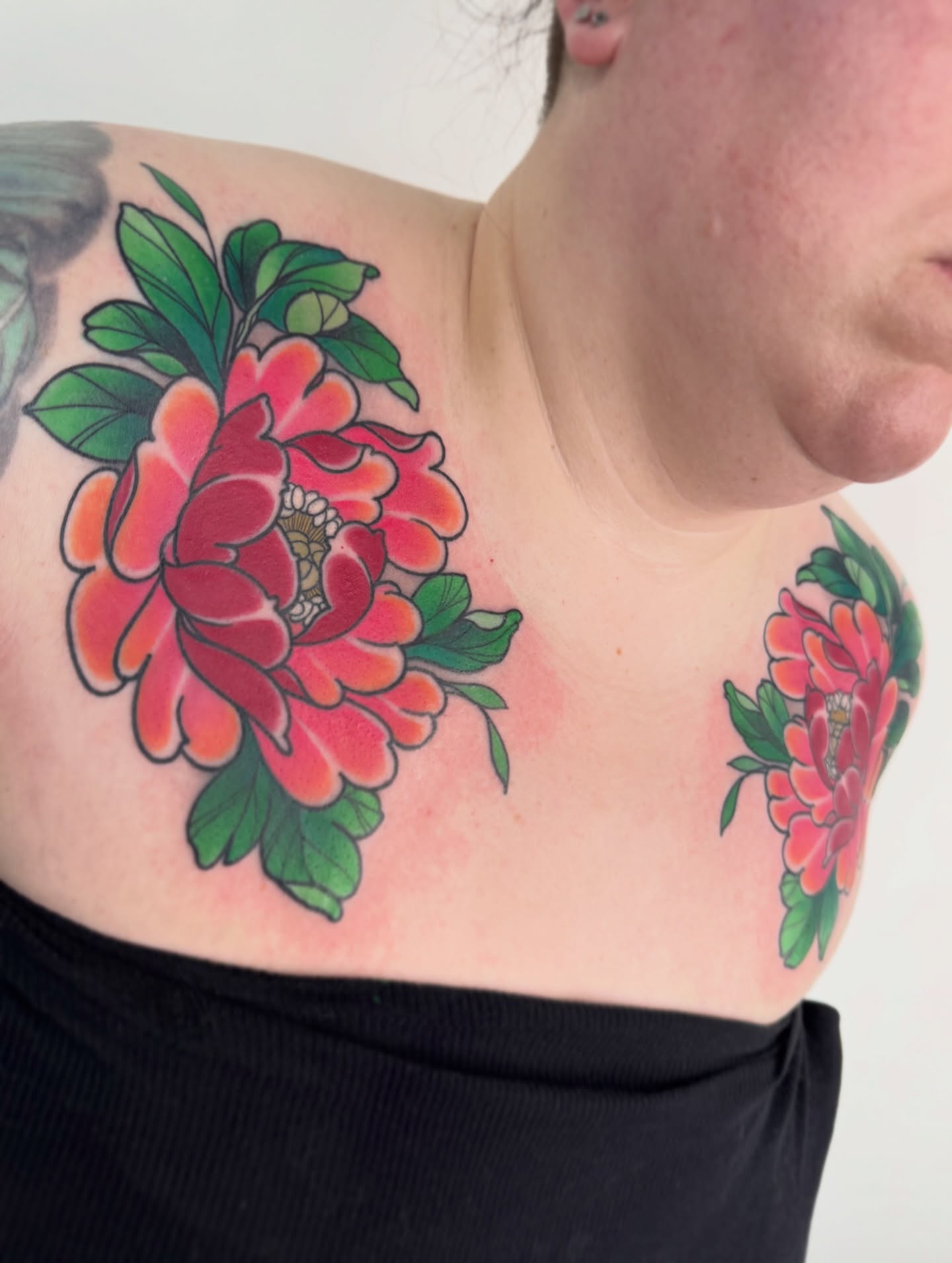 Peony American traditional tattoo on the chest by Anne Cornelson