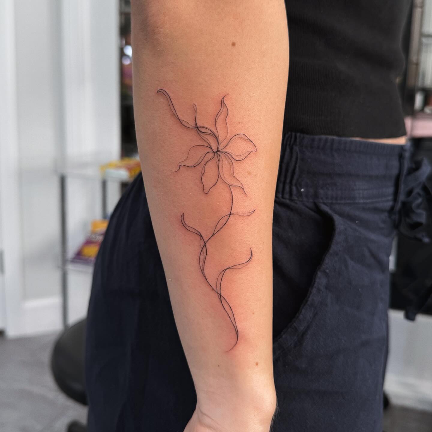 Flower fine line tattoo on the forearm by Jennifer Garcia R - Vegas tattoo artist