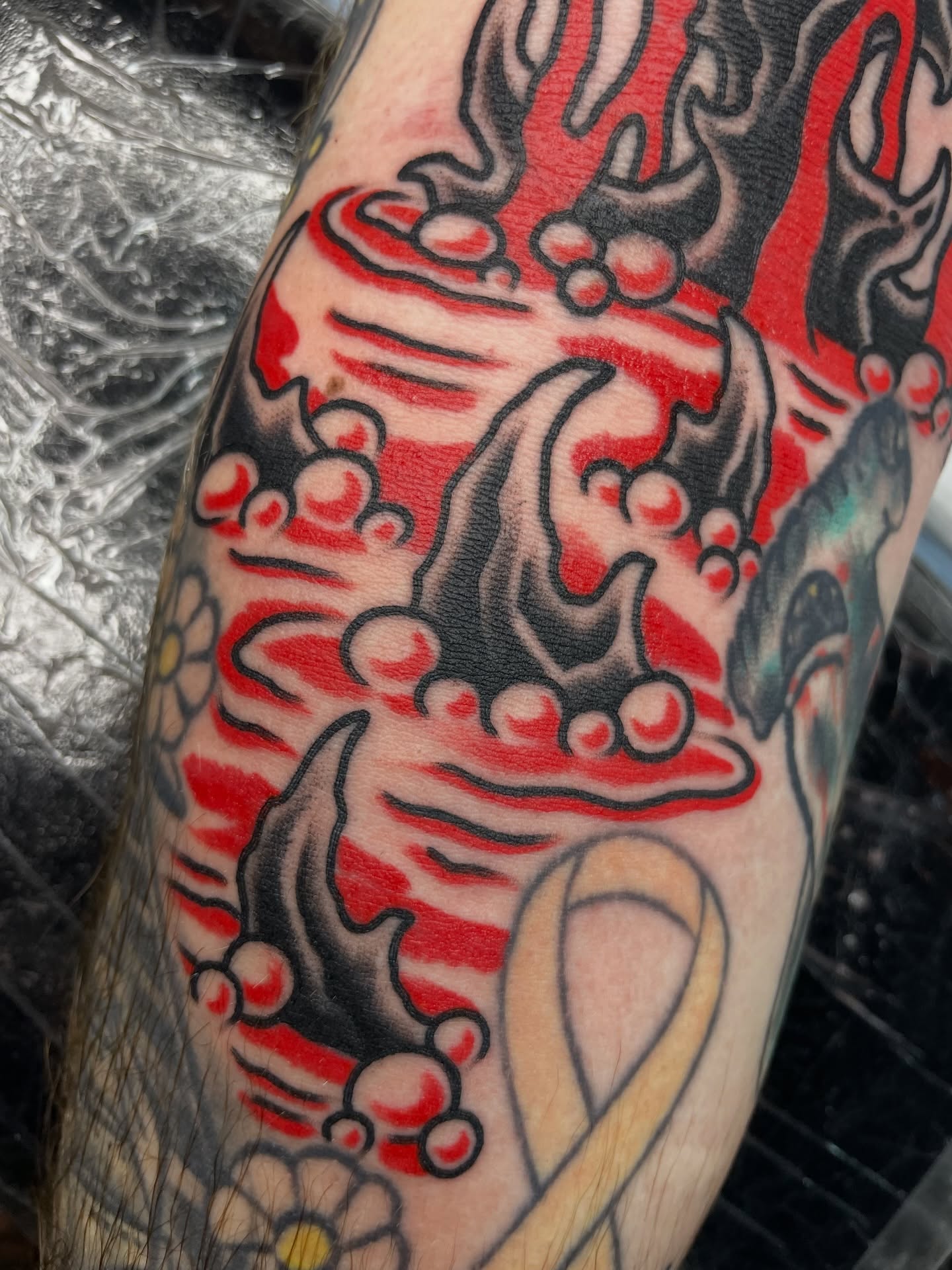 Wave and crown American traditional tattoo on the forearm by Tom Taylor, Philadelphia, Pennsylvania