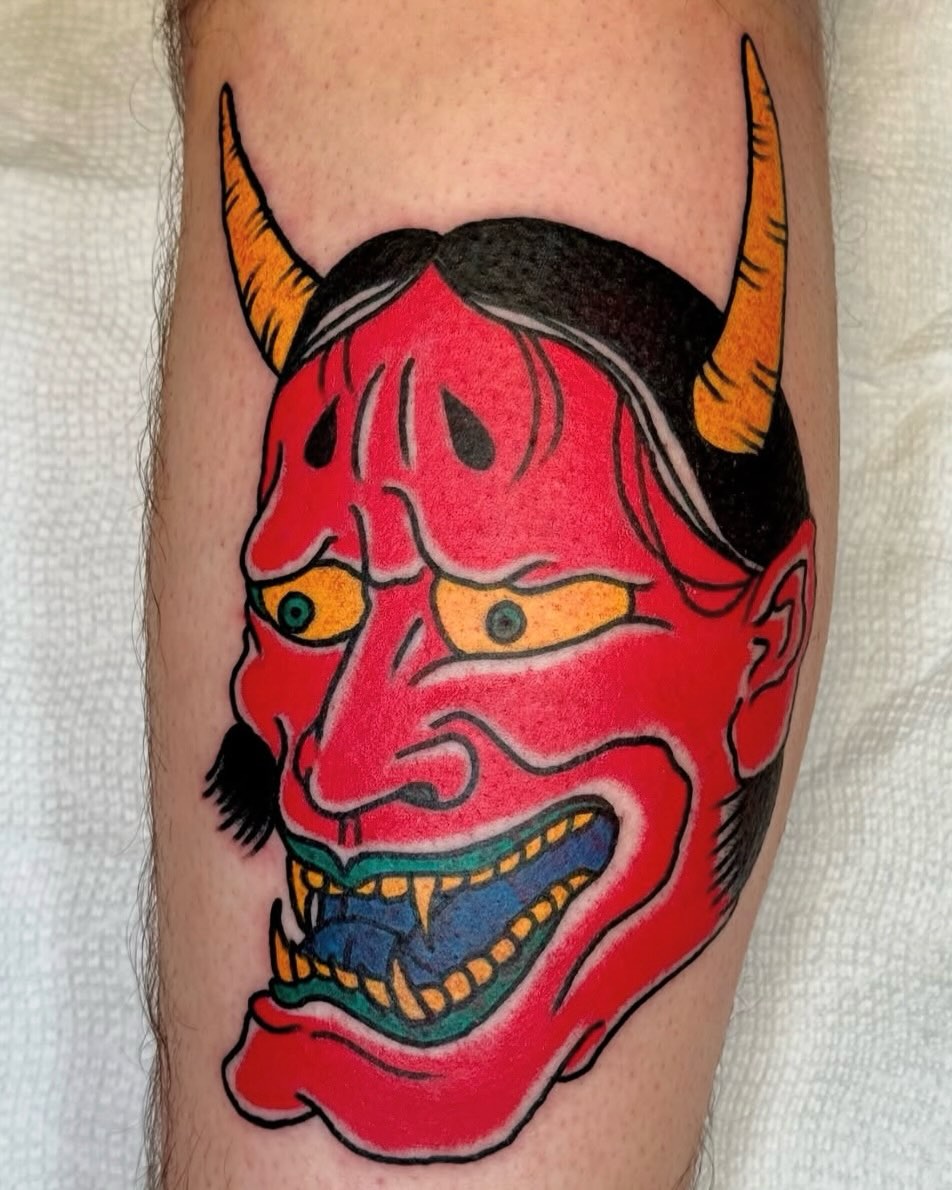 Demon mask American traditional tattoo on the forearm by Joe Bear Tattooer