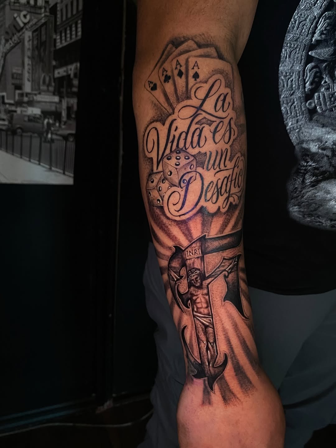 Jesus on cross and lettering Chicano tattoo on the forearm by Irving Guzman