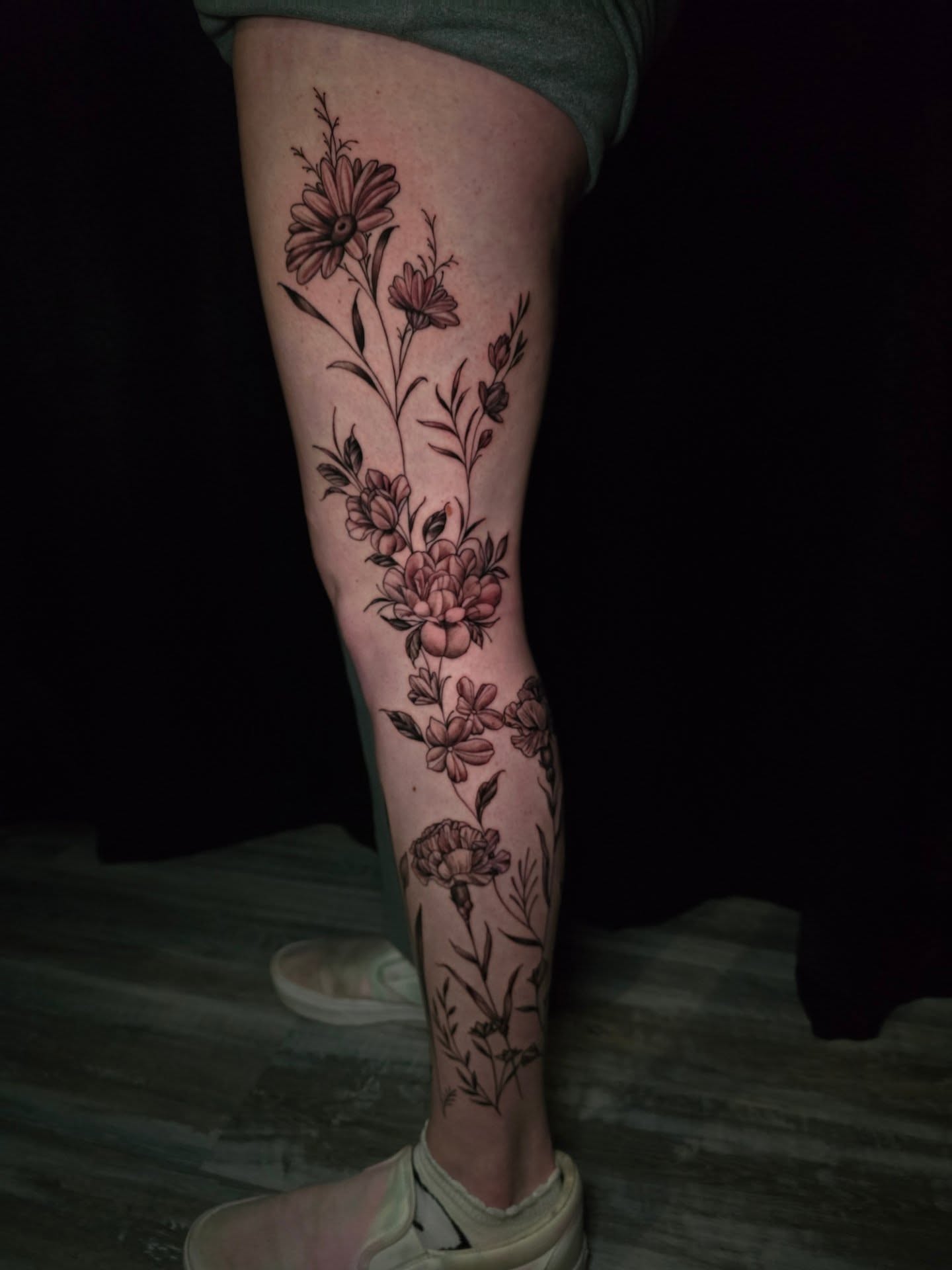 Floral bouquet black and grey tattoo on the calf by Camuel Whaley