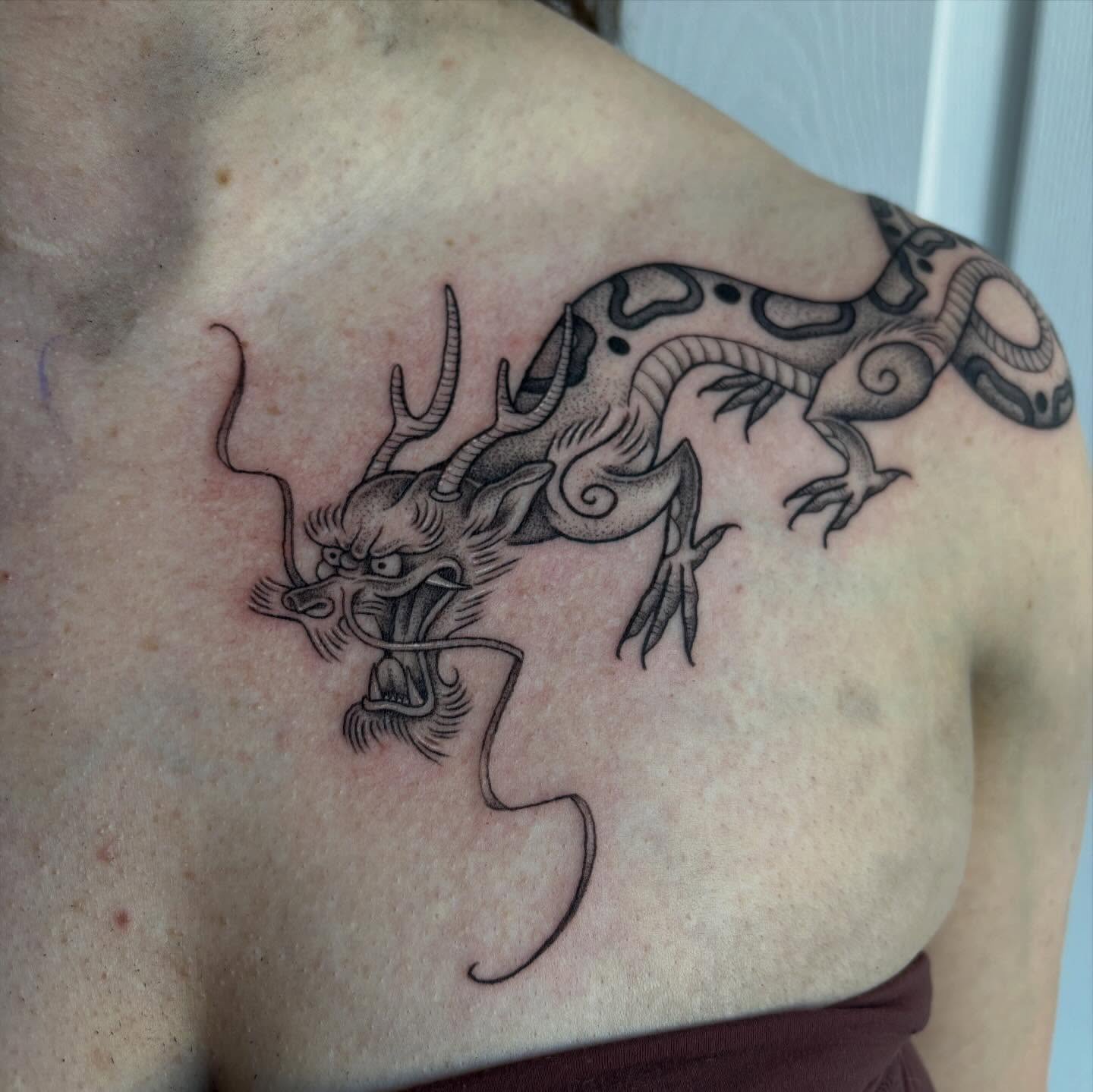 Dragon black and grey tattoo on the shoulder by Hailey Nicole