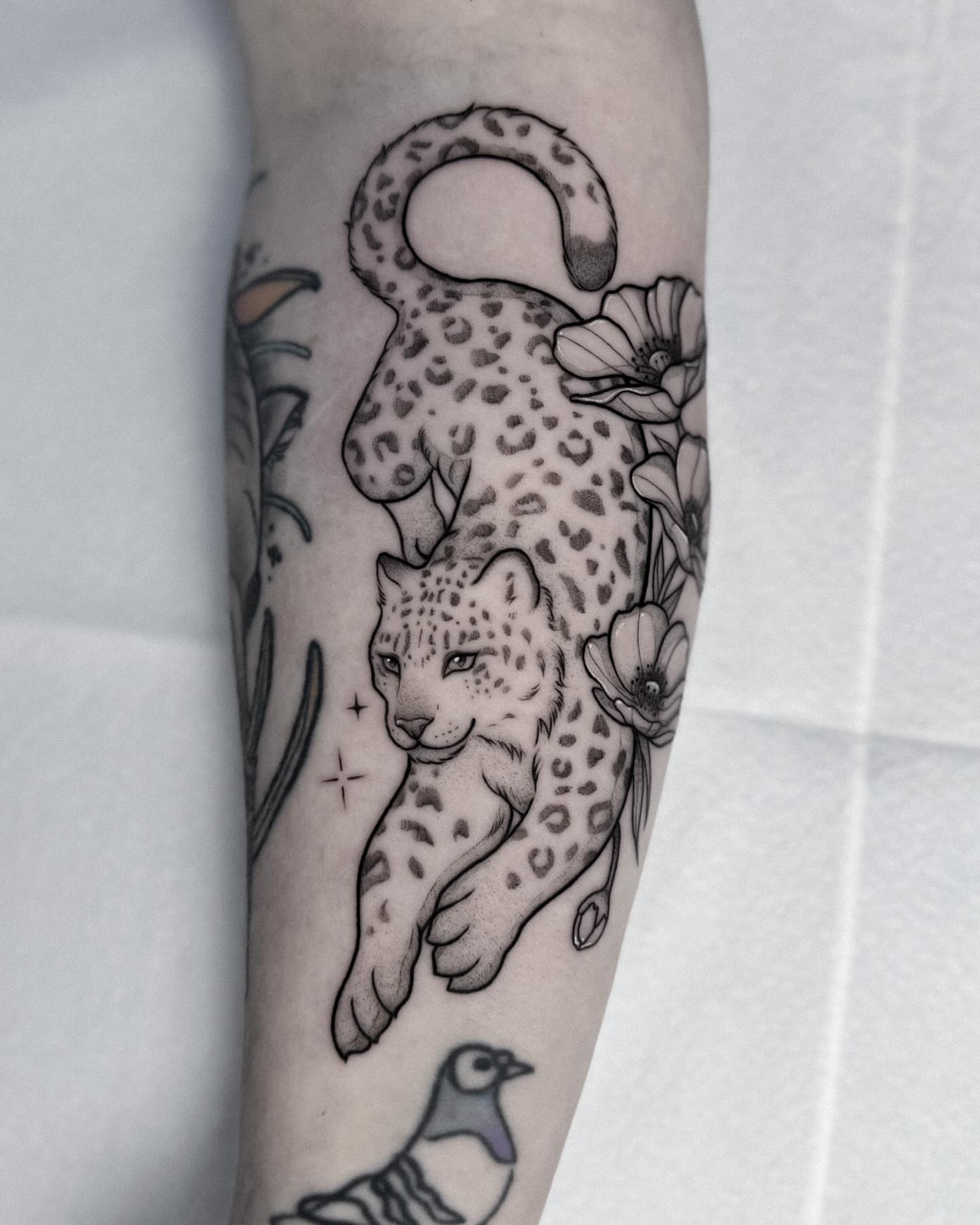Leopard black and grey tattoo on the forearm by Whimsical Tattoos