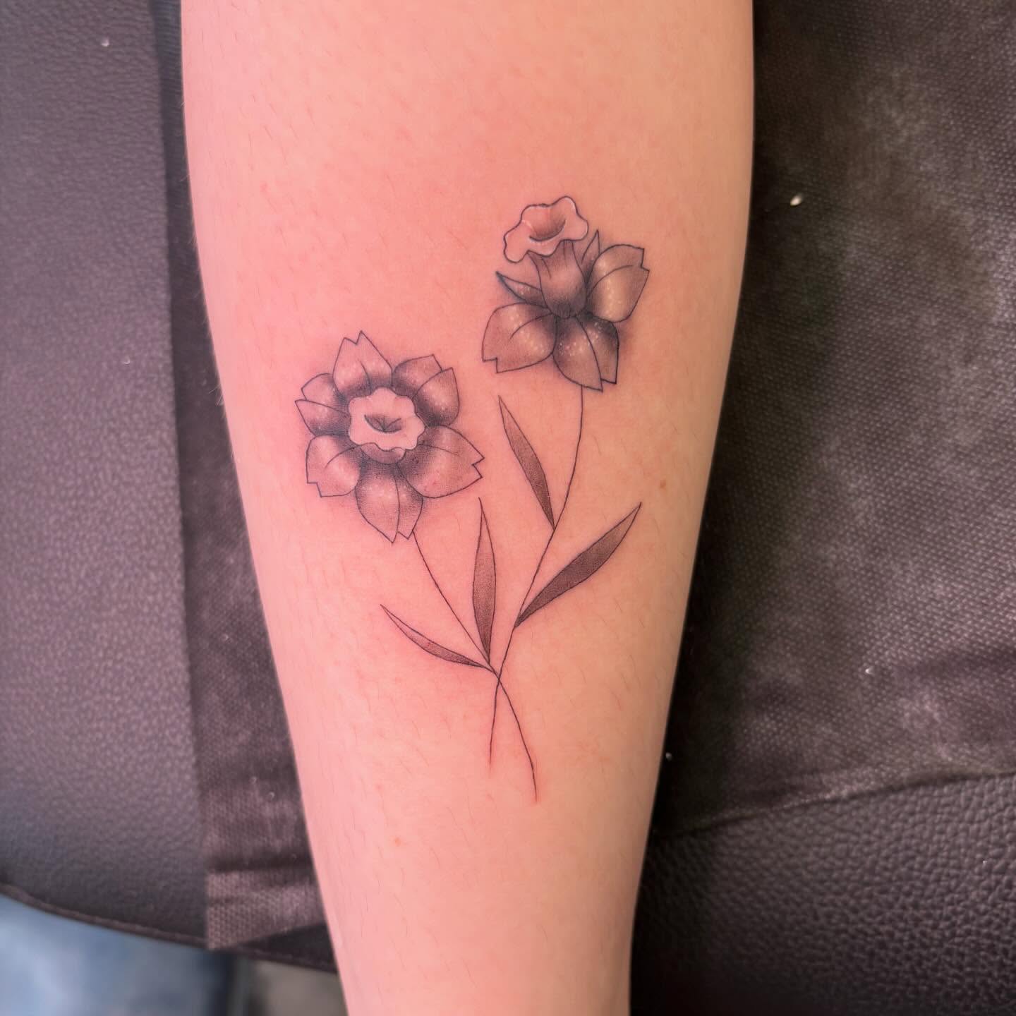 Flowers black and grey tattoo on the forearm by alana khounmeuang