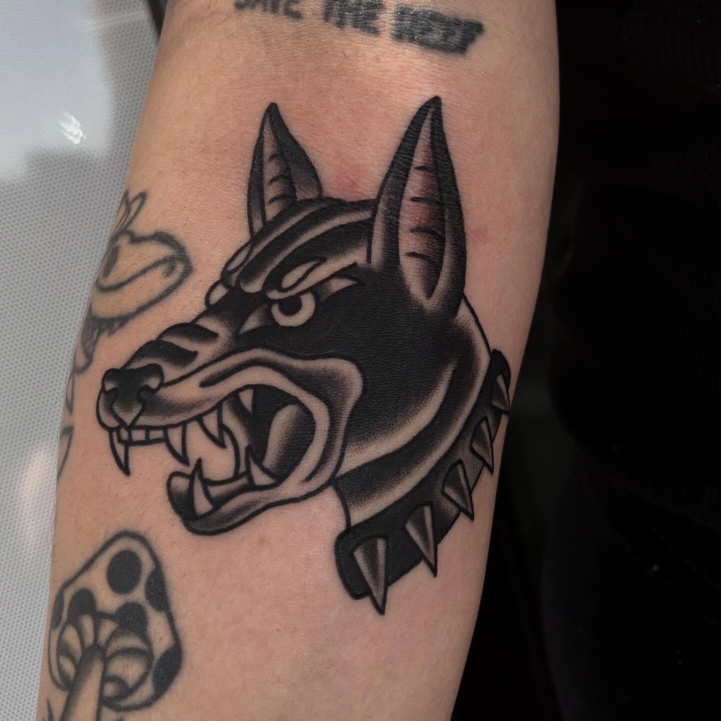 Wolf head black and grey tattoo on the forearm by Allyson Monique