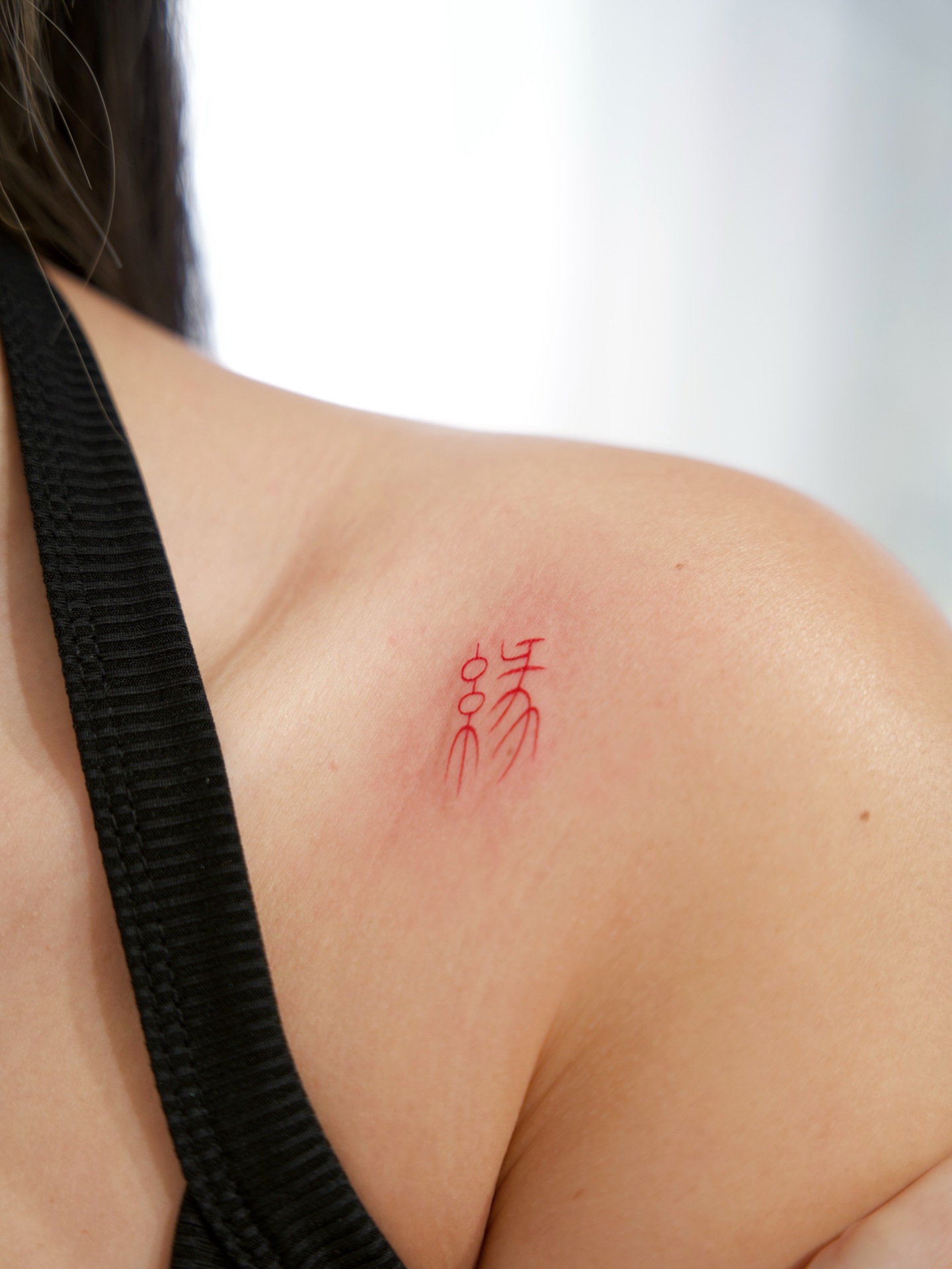 Red inked characters lettering script tattoo on the shoulder by 𝕁𝕖𝕞, Richmond, British Columbia