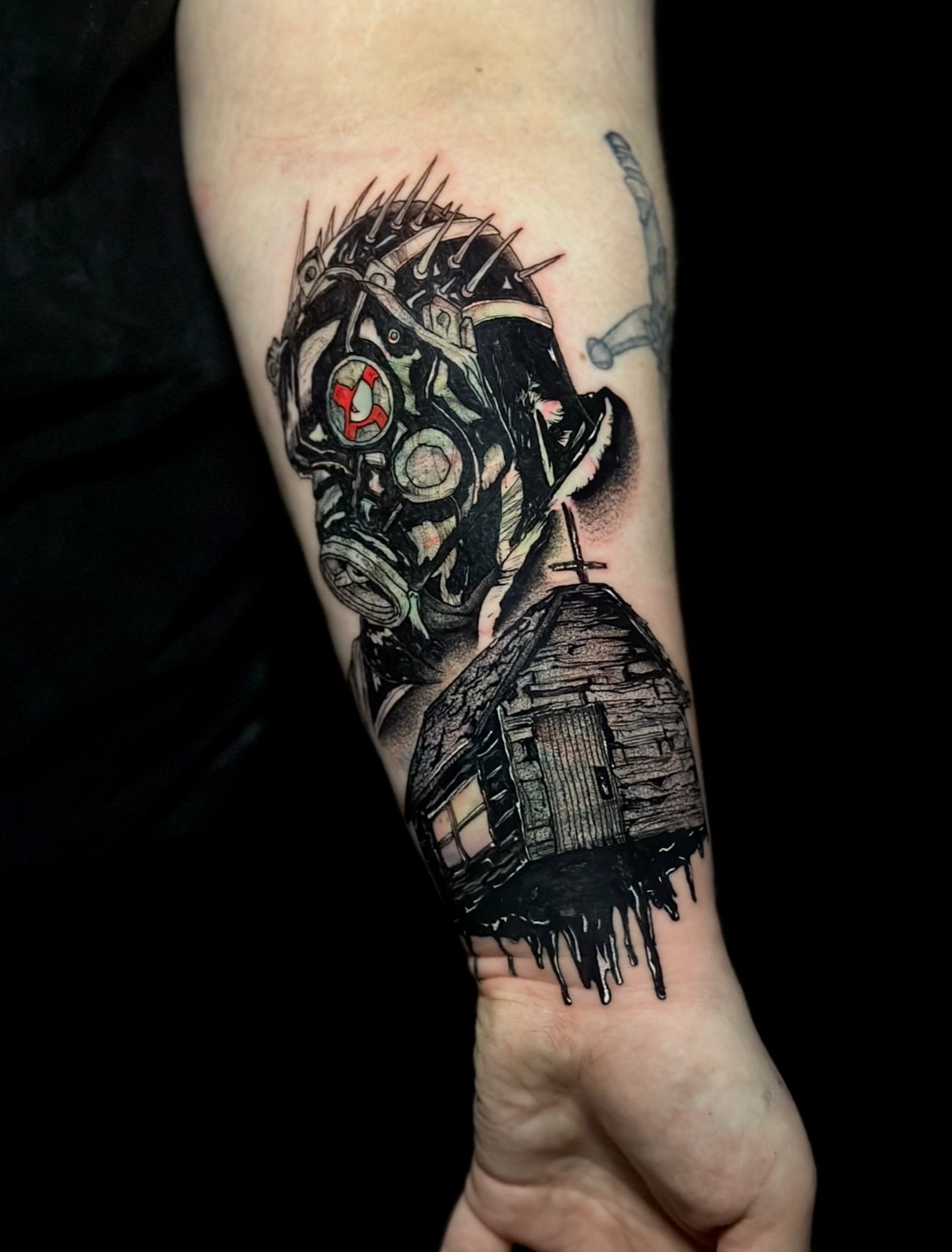 Gas mask and house dark realism tattoo on the forearm by Sabrina, Harrison, New Jersey