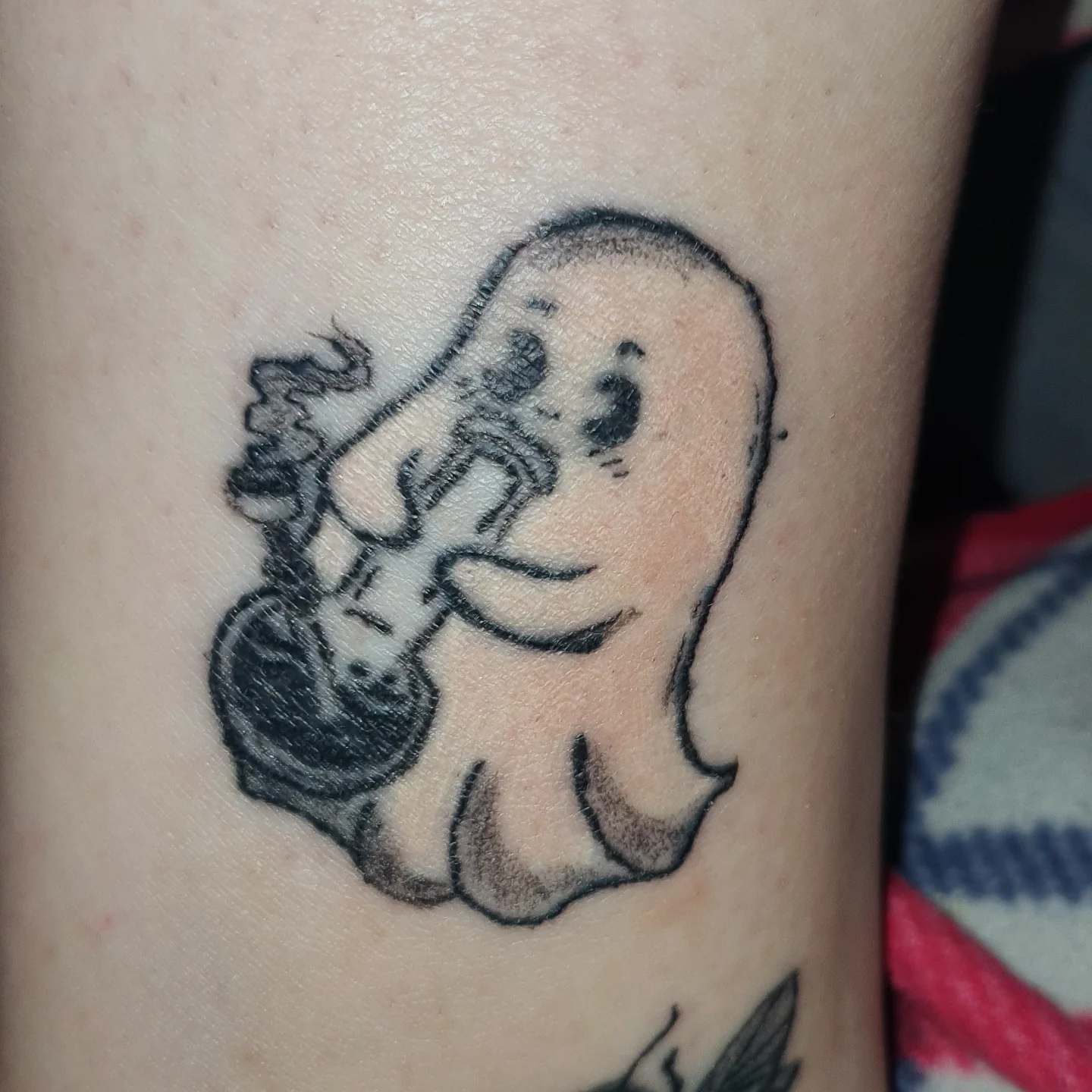 Octopus playing guitar black and grey tattoo on the forearm by Artful Ink