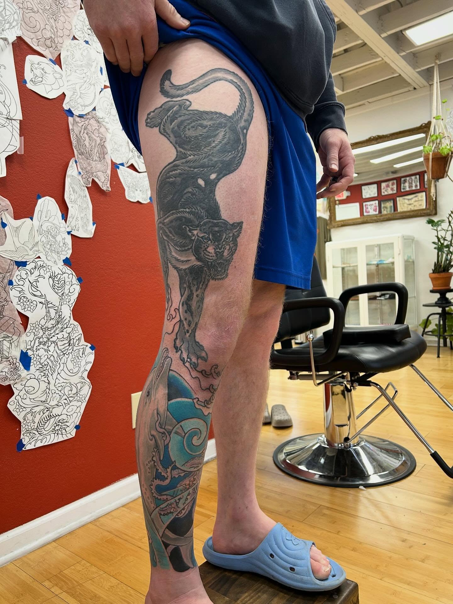 Panther black and grey tattoo on the thigh by Matthew Crimson