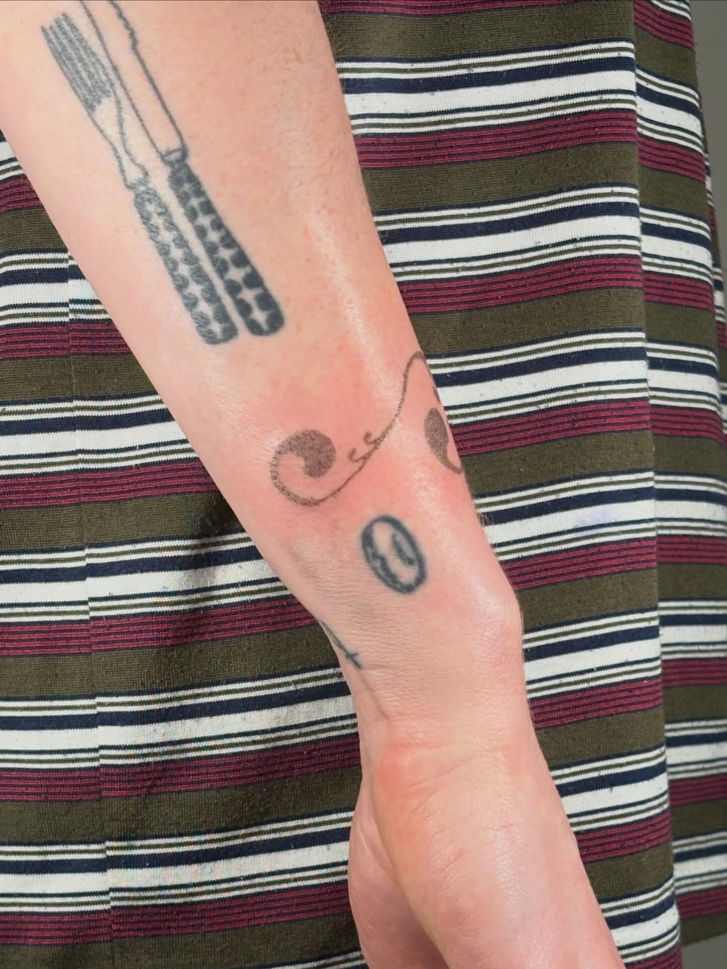 Fork and knife black and grey tattoo on the forearm by Jill