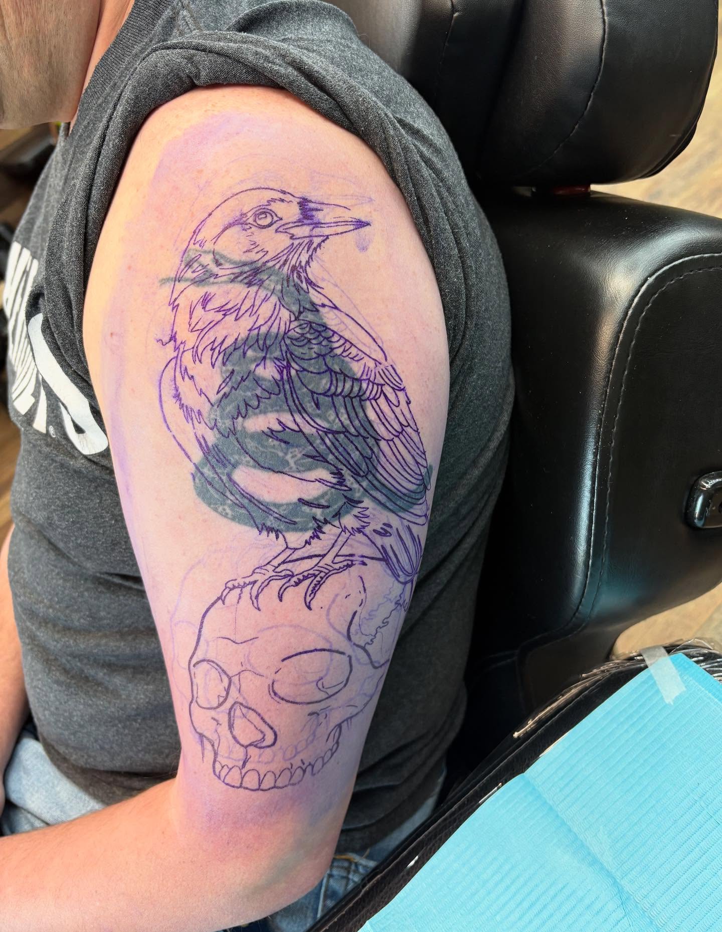 Crow and skull American traditional tattoo on the upper arm by Robbie Reel, Wichita, Kansas