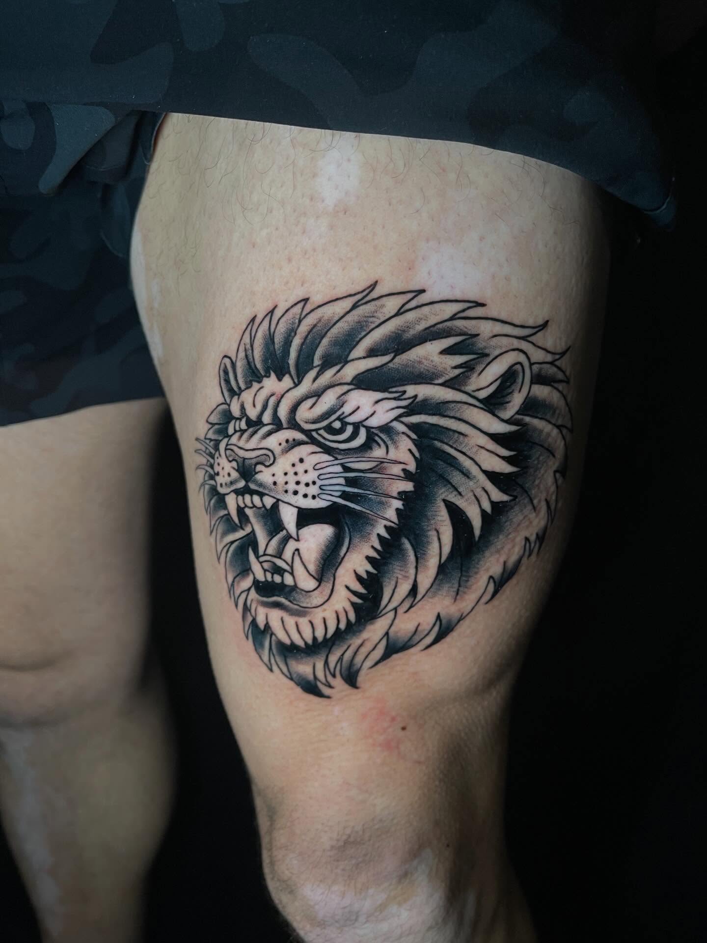 Lion black and grey tattoo on the thigh by Josh Brownell