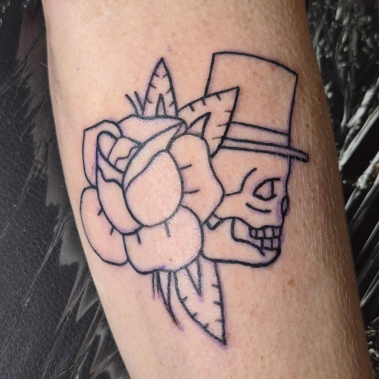 Rose and skull American traditional tattoo on the forearm by Bobby H