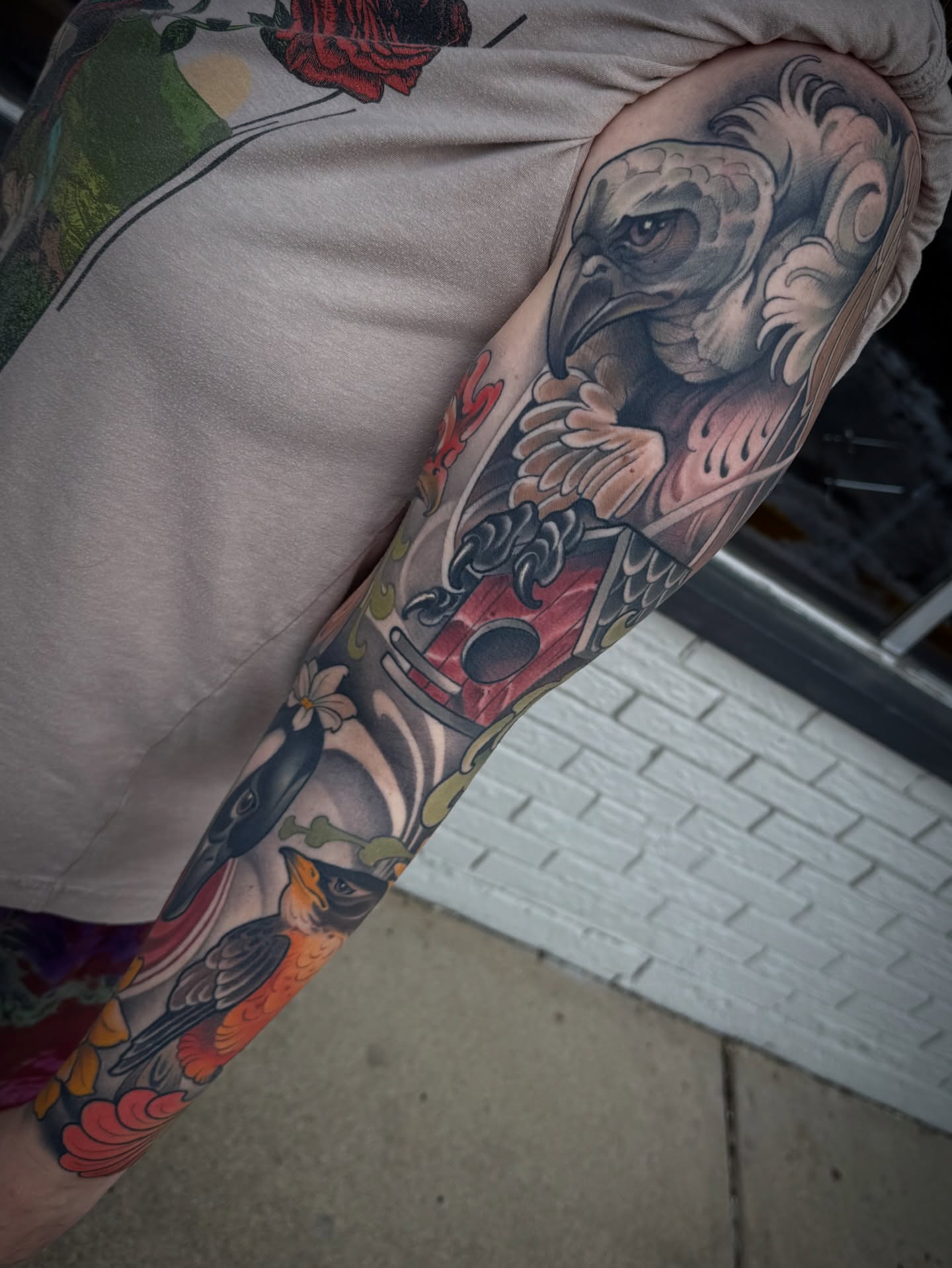 Bird and floral American traditional tattoo on the forearm by Freddie Brown, Lombard, IL