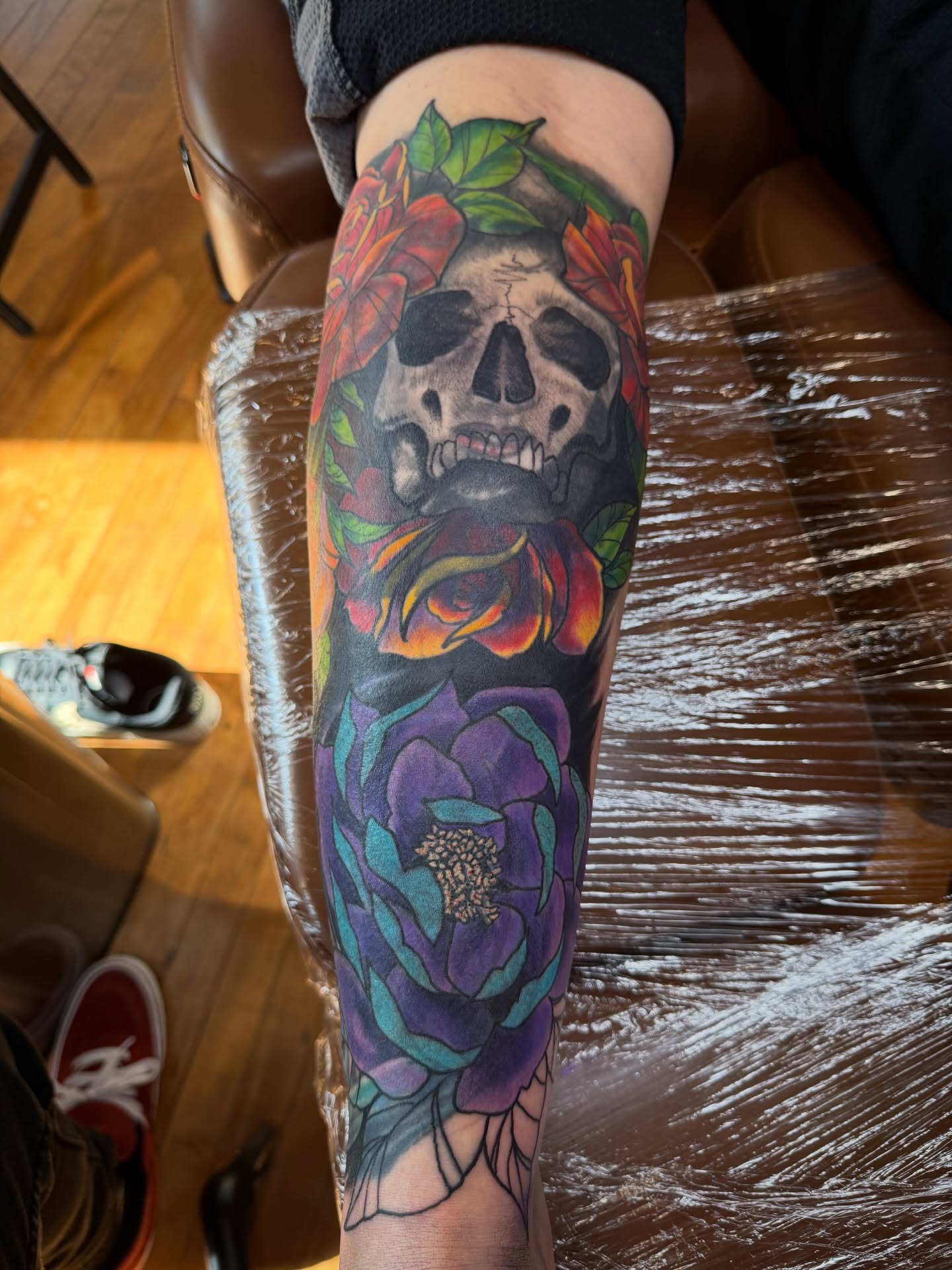 Skull and roses realism tattoo on the forearm by steven