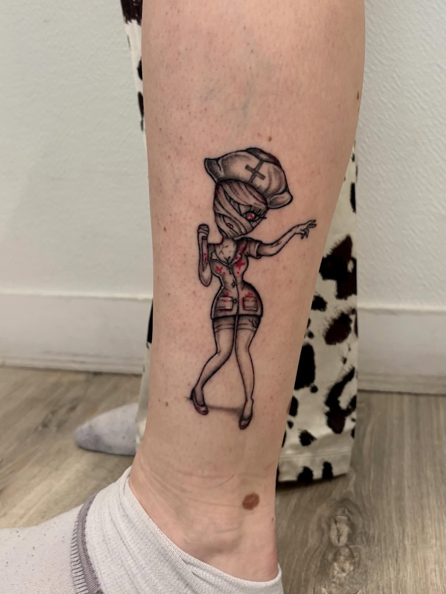 Nurse zombie black and grey tattoo on the forearm by Deborah