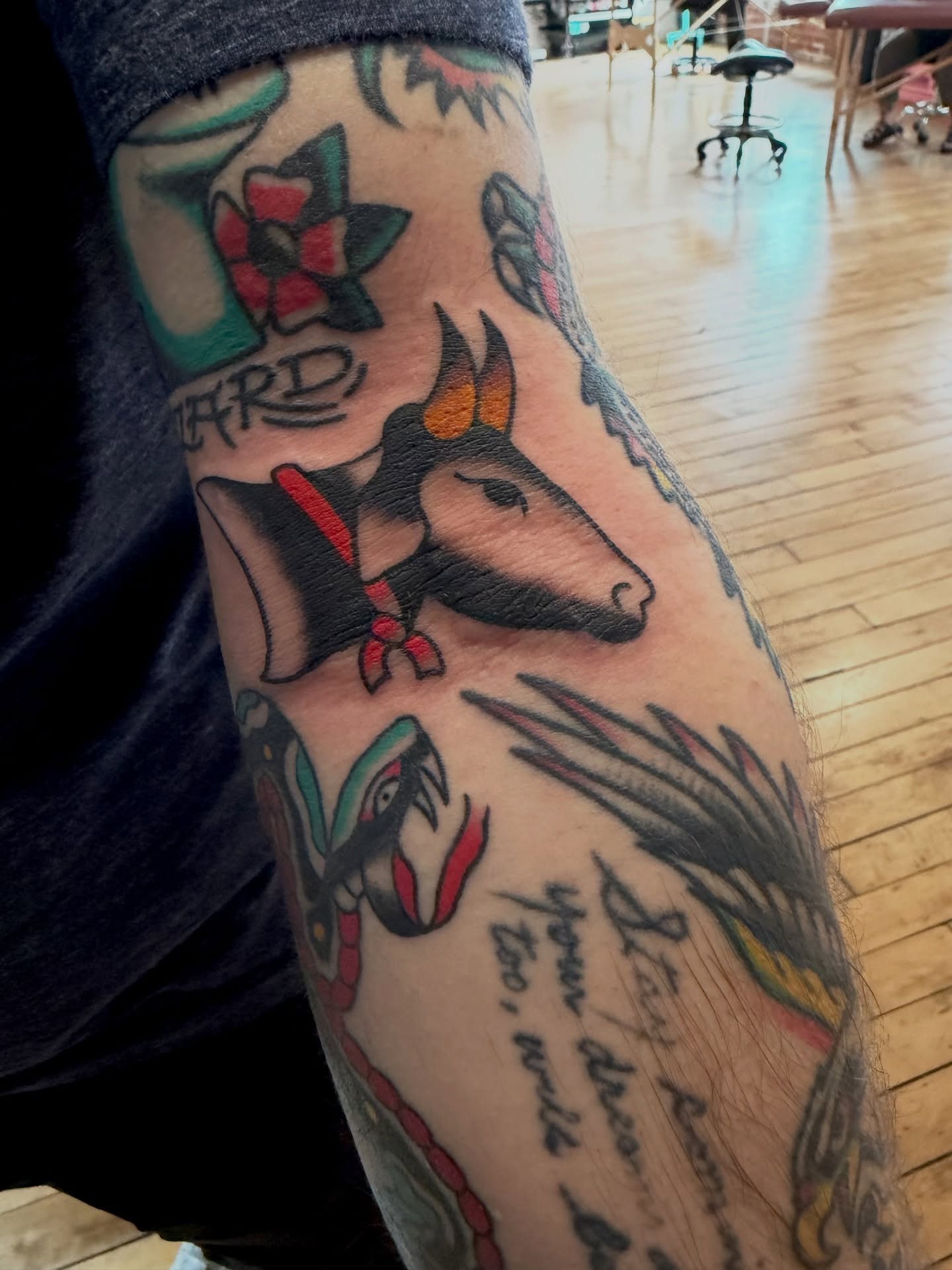 Bull and floral American traditional tattoo on the forearm by Steven