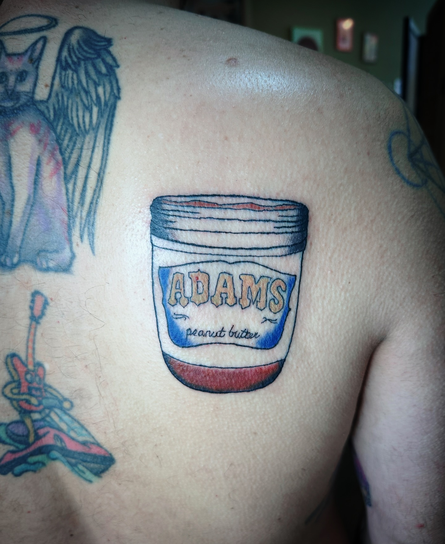 Peanut butter jar realism tattoo on the shoulder by Madeline Seeley