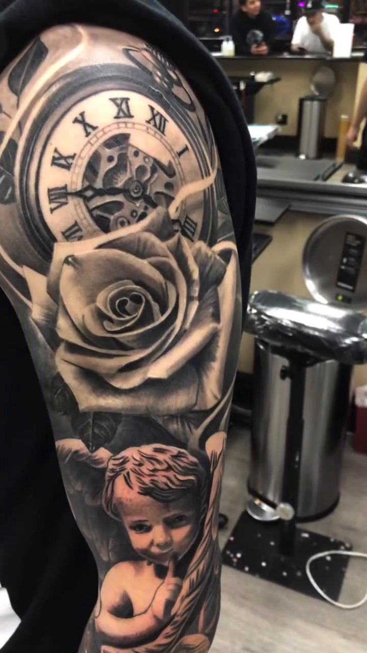 Clock, rose, and cherub realism tattoo by Mark Phillip Chavez