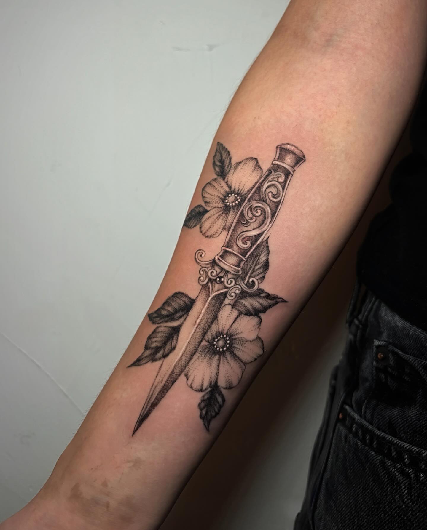 Knife and flowers realism tattoo on the forearm by l i z ✶