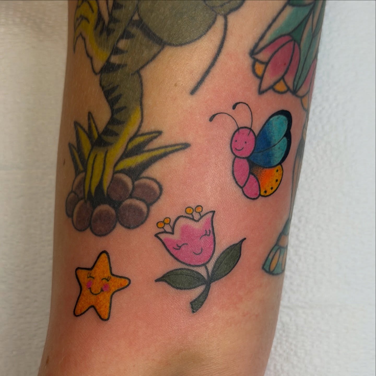 Butterfly and flower American traditional tattoo on the forearm by Kailey Ru, Knoxville, Tennessee