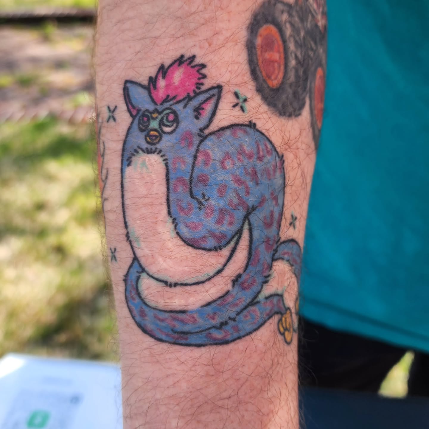 Monster trash polka tattoo on the forearm by K.F. Golden