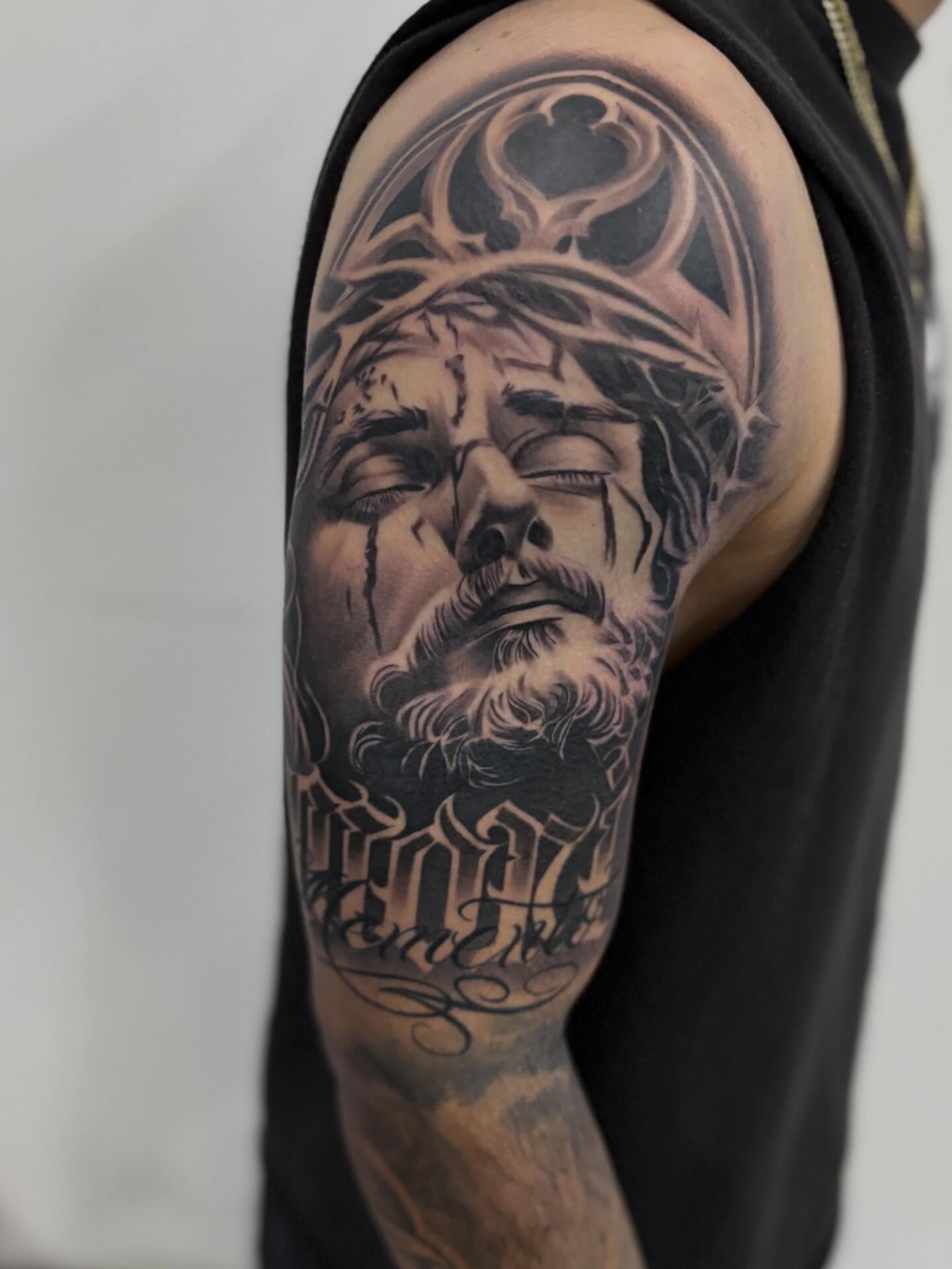 Man's face realism tattoo on the shoulder by Devin