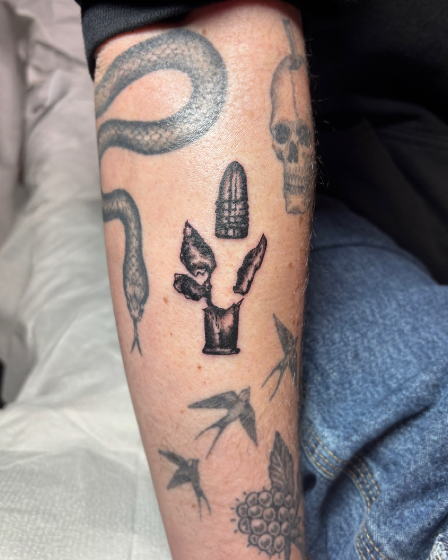 Bullet and cactus black and grey tattoo on the forearm by Cooper, Portland, Oregon