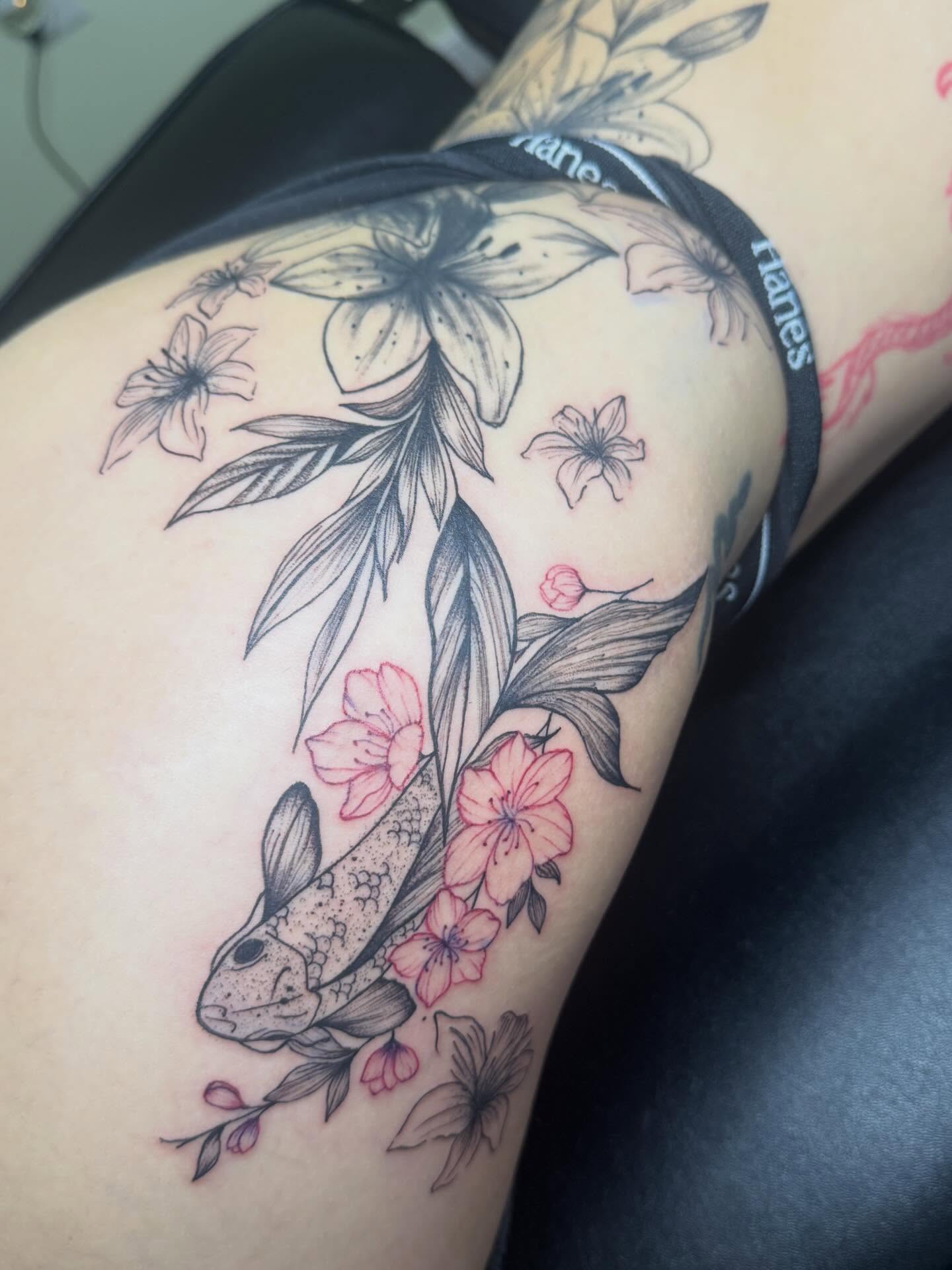 Koi fish and flowers realism tattoo on the thigh by Destini
