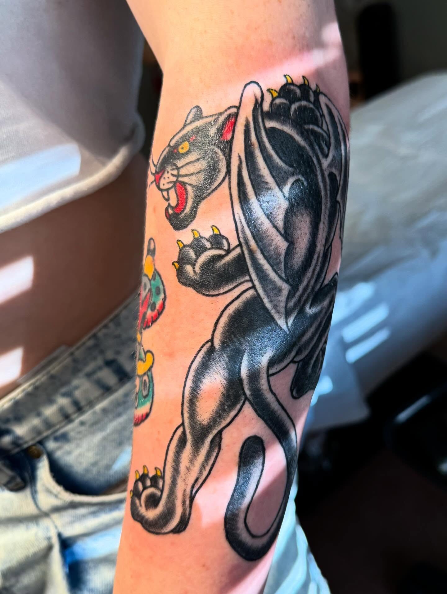 Panther American traditional tattoo on the forearm by Spencer Coco