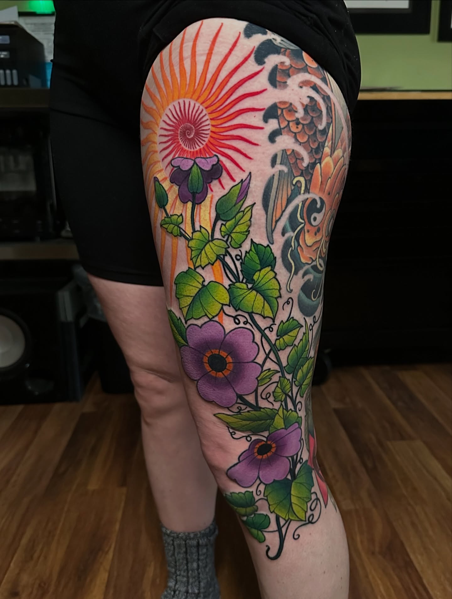 Floral and sun design japanese irezumi tattoo on the thigh by Trevor Burtz