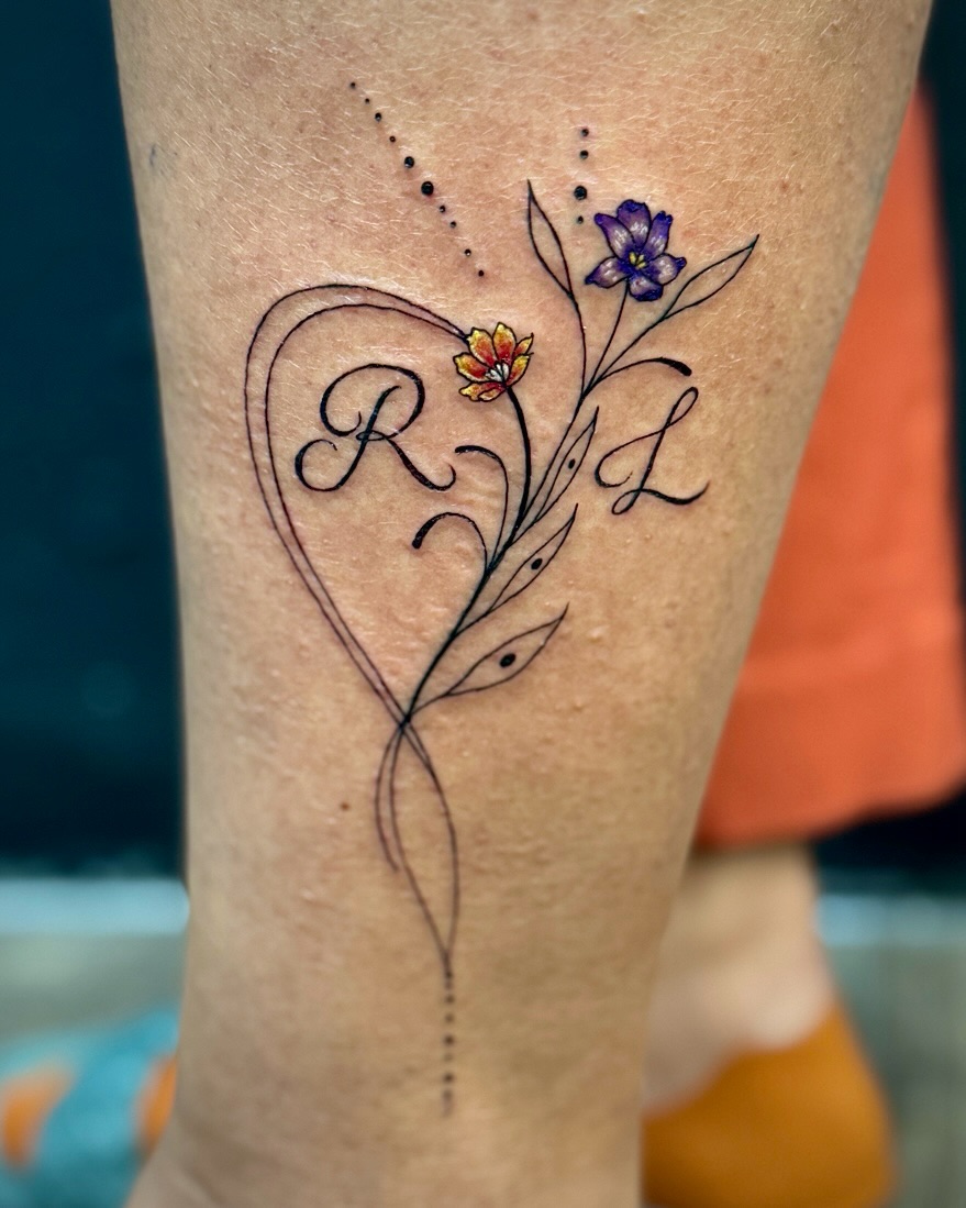 Floral heart with initials fine line tattoo on the forearm by David
