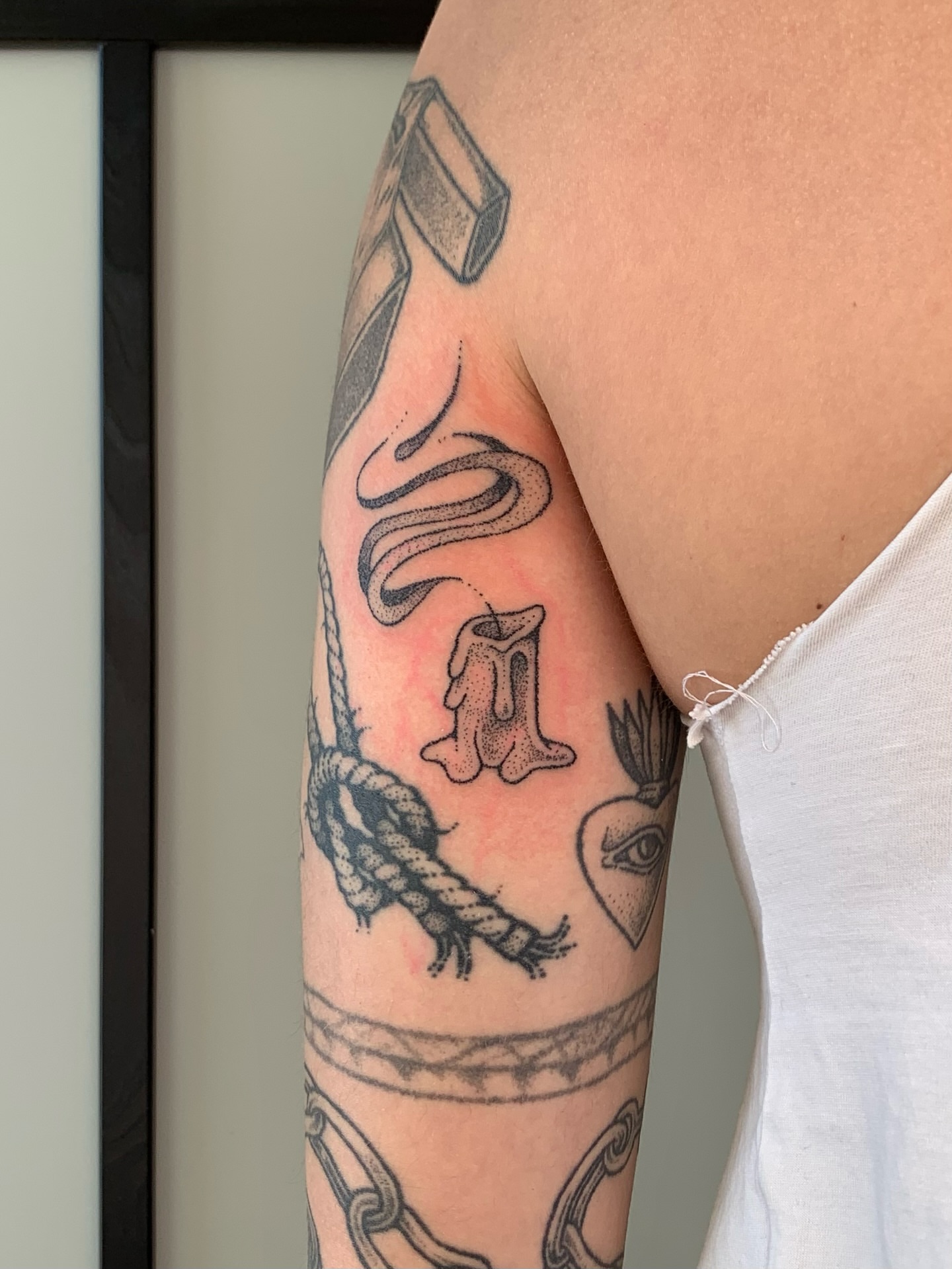Smoke, rope, candle, eye, chain black and grey tattoo on the forearm by Lex Lloyd