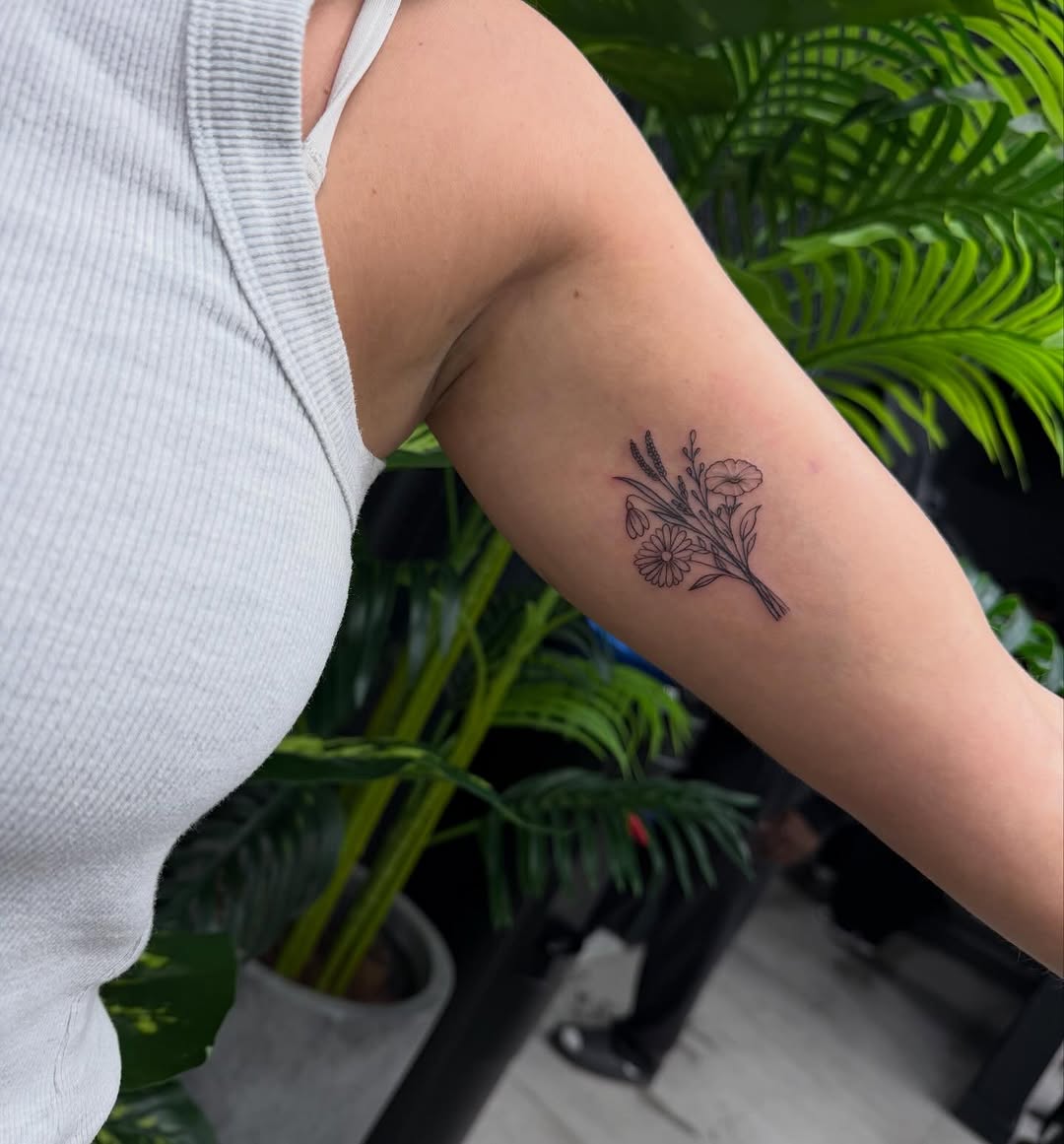 Bouquet of flowers fine line tattoo on the forearm by Lina Valentina, New York, New York