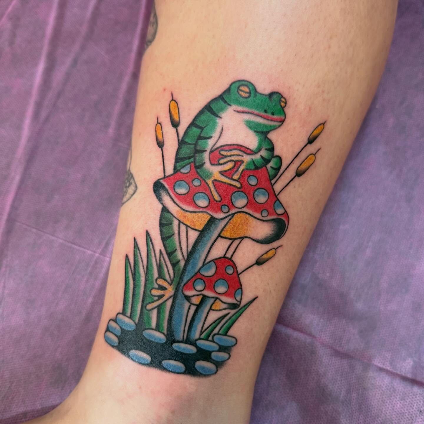 Frog on mushroom American traditional tattoo on the forearm by charlie