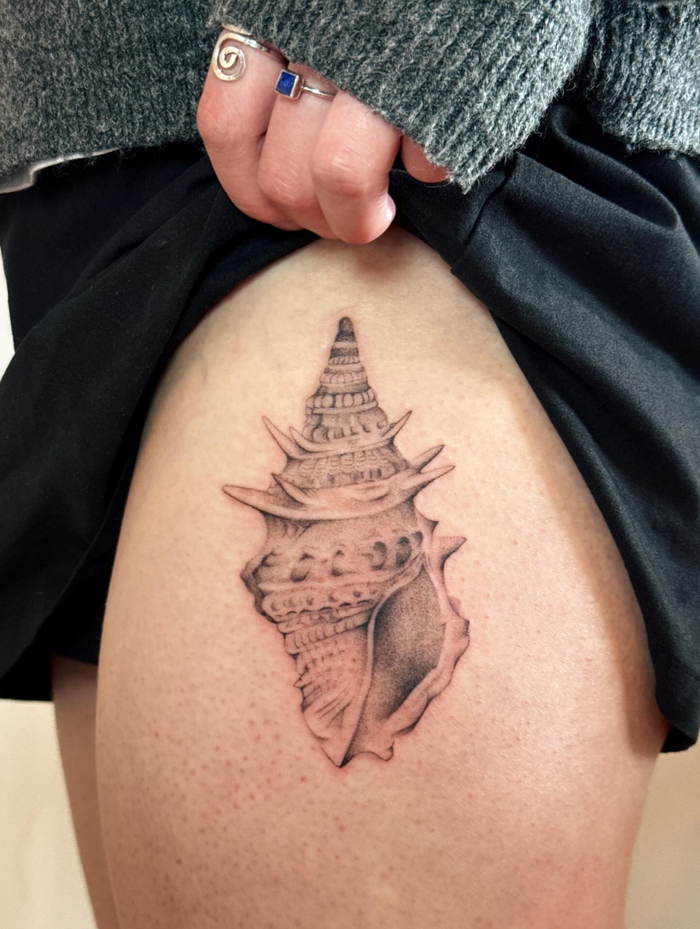 Shell black and grey tattoo on the thigh by tattoos by miss jackie o 🎱
