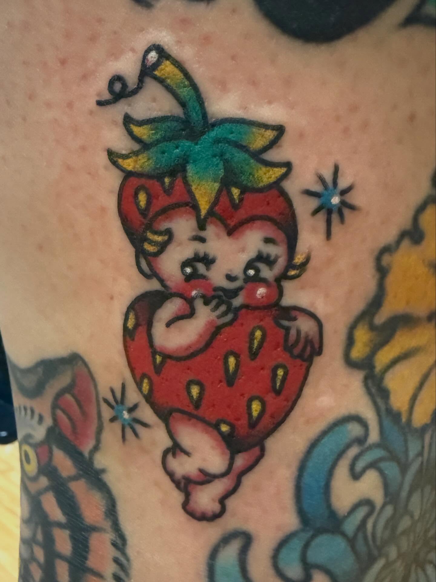 Strawberry baby American traditional tattoo on the upper arm by Tony Beuke
