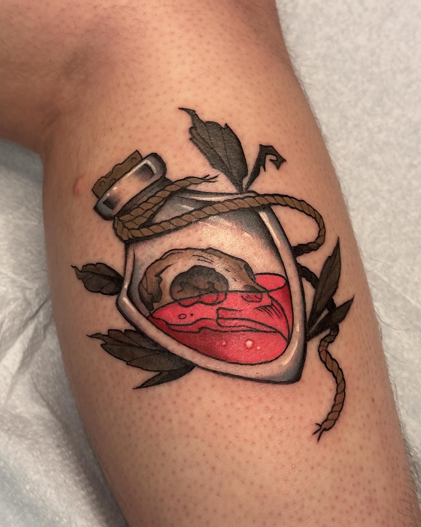Glass bottle with contents realism tattoo on the forearm by Craig Ryans