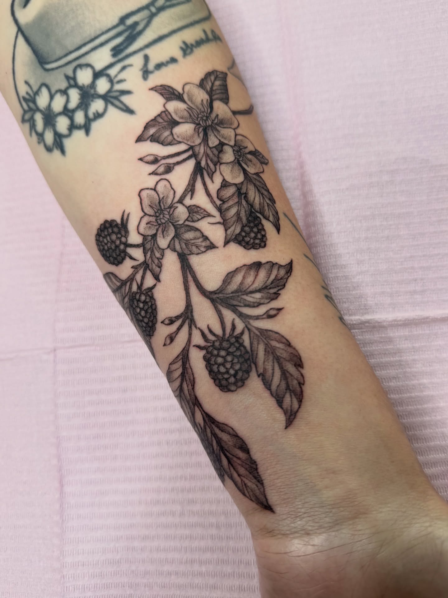 Berry bush black and grey tattoo on the forearm by Chloe Marie